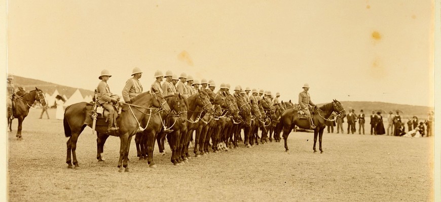 A row of mounted troops lined lined up behind behind their commander