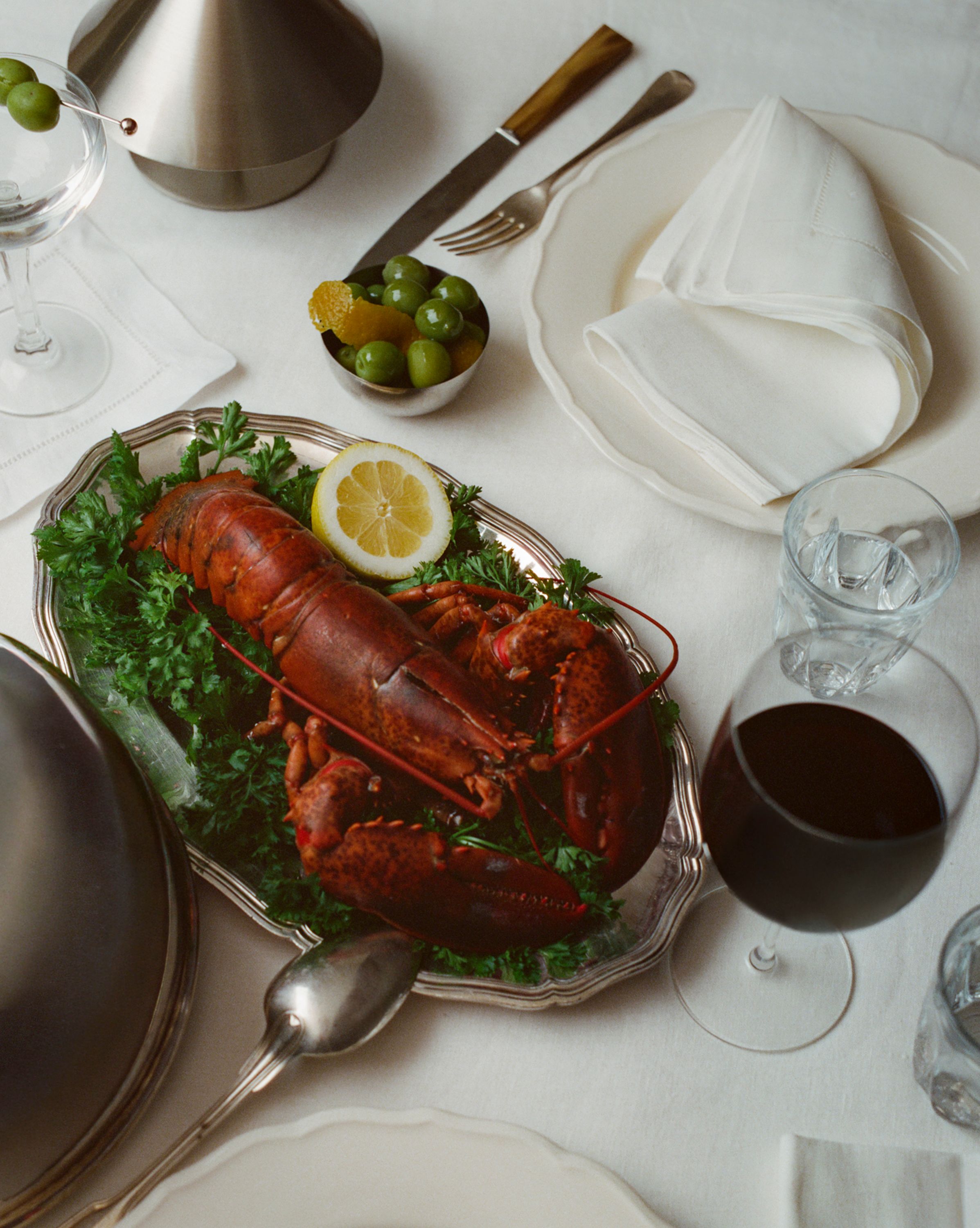 Dinner plate with lobster and a glass of wine