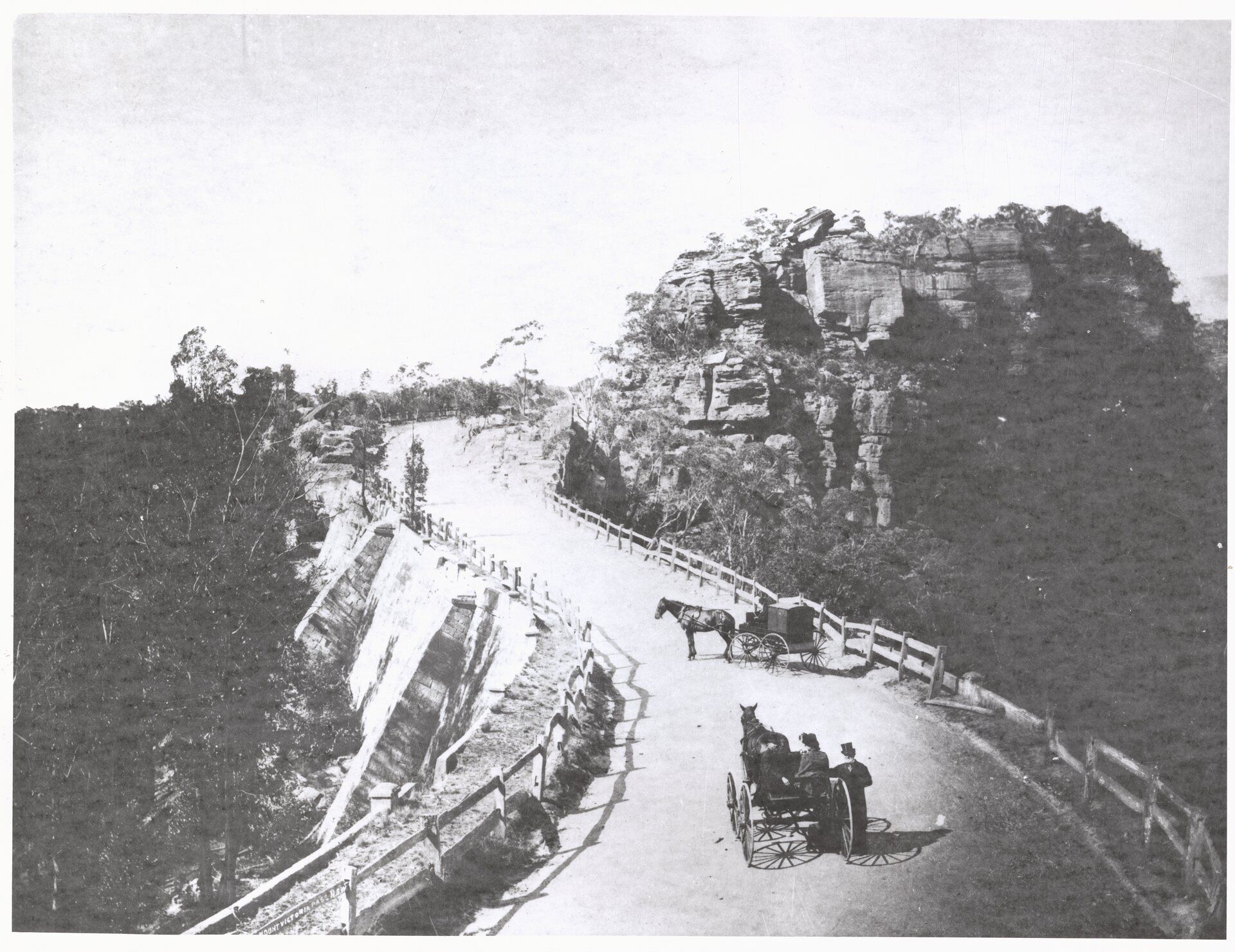 Two horses and carts stopped on a steep road