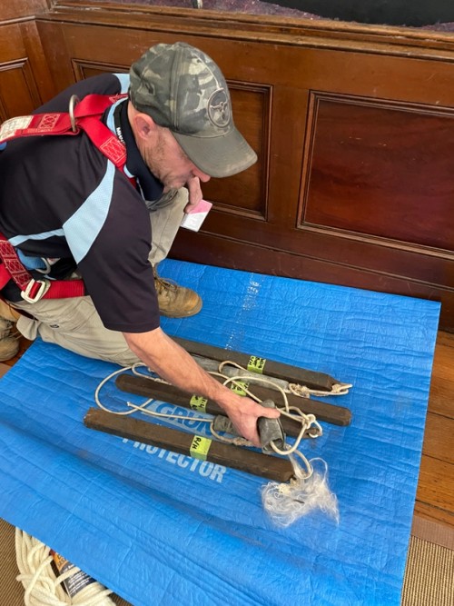 Conservation joiner documenting original sash weights 