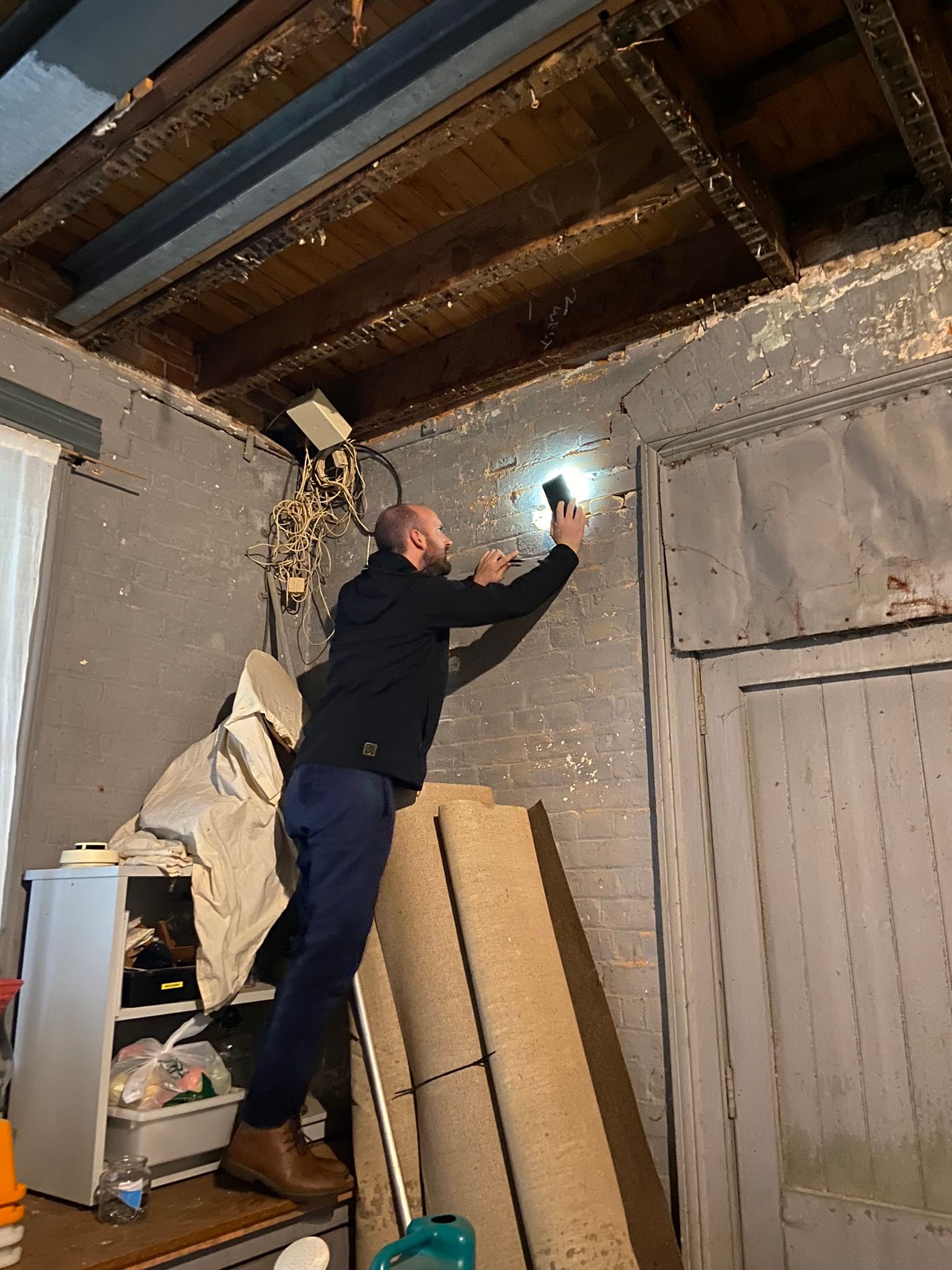 Engineer inspecting the south wall of larder