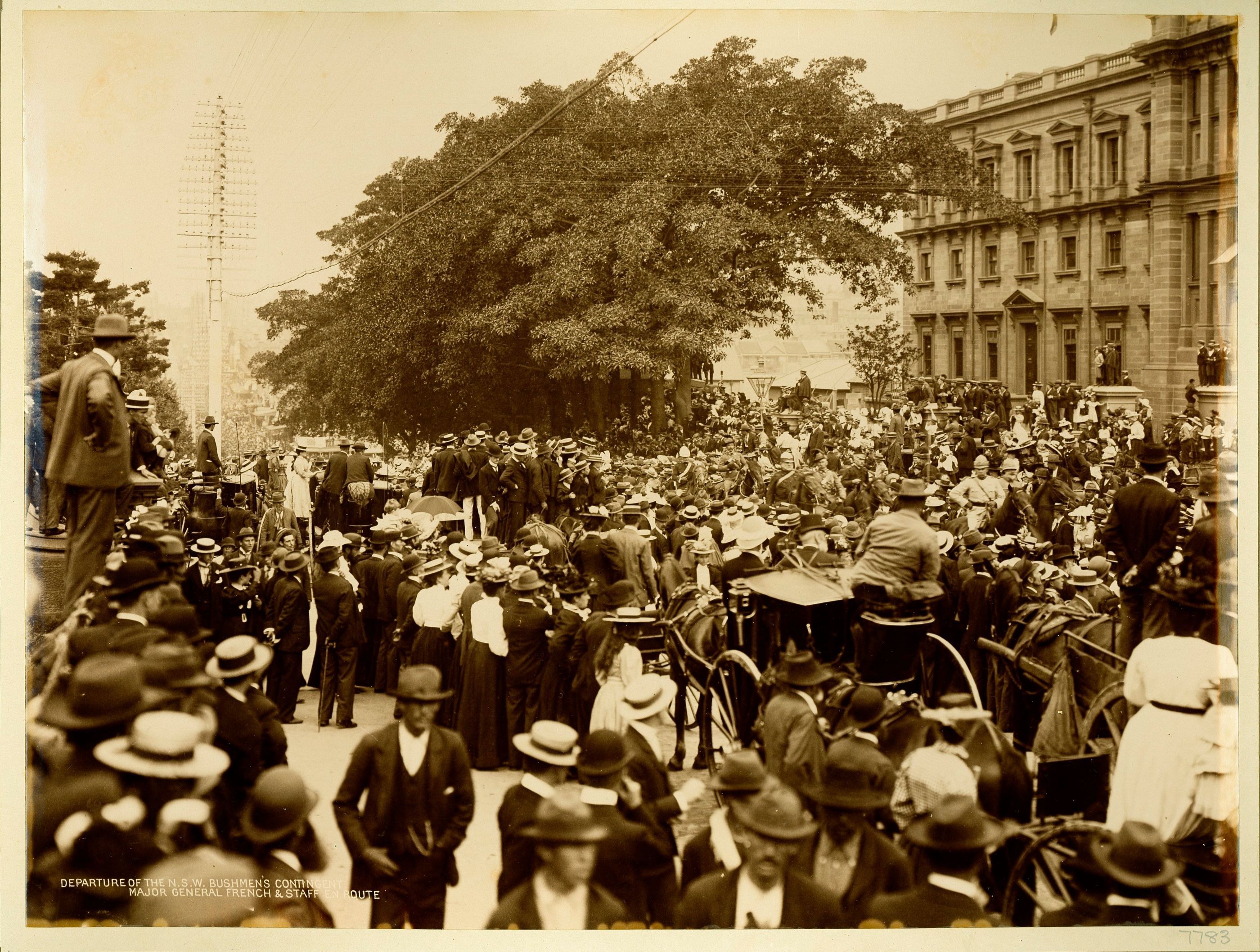 Large crowds watch a military procession