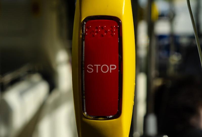 a stop button on a train, tram, or bus