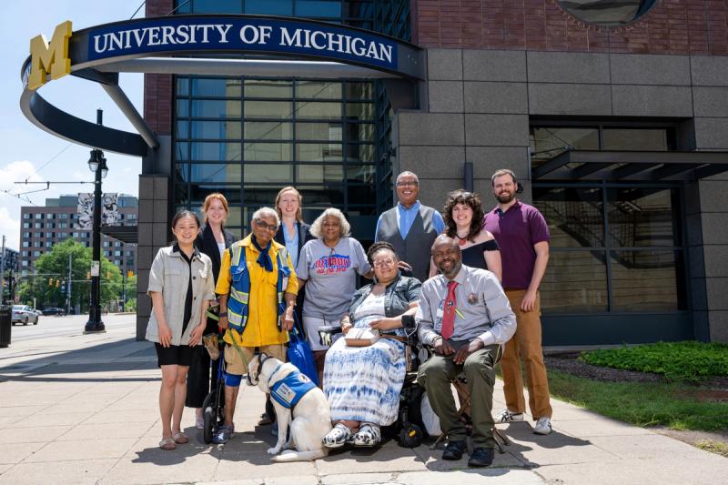 The CIME team and Community Experts in front of a University of Michigan building.