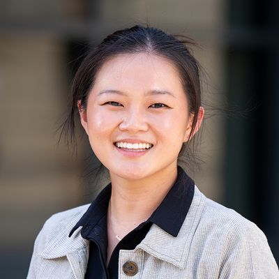 Jennifer Choi, wearing a grey coat, facing the camera