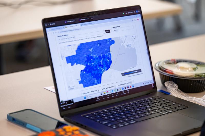 A laptop open on a table displaying the Public Transit Accessibility Dashboard