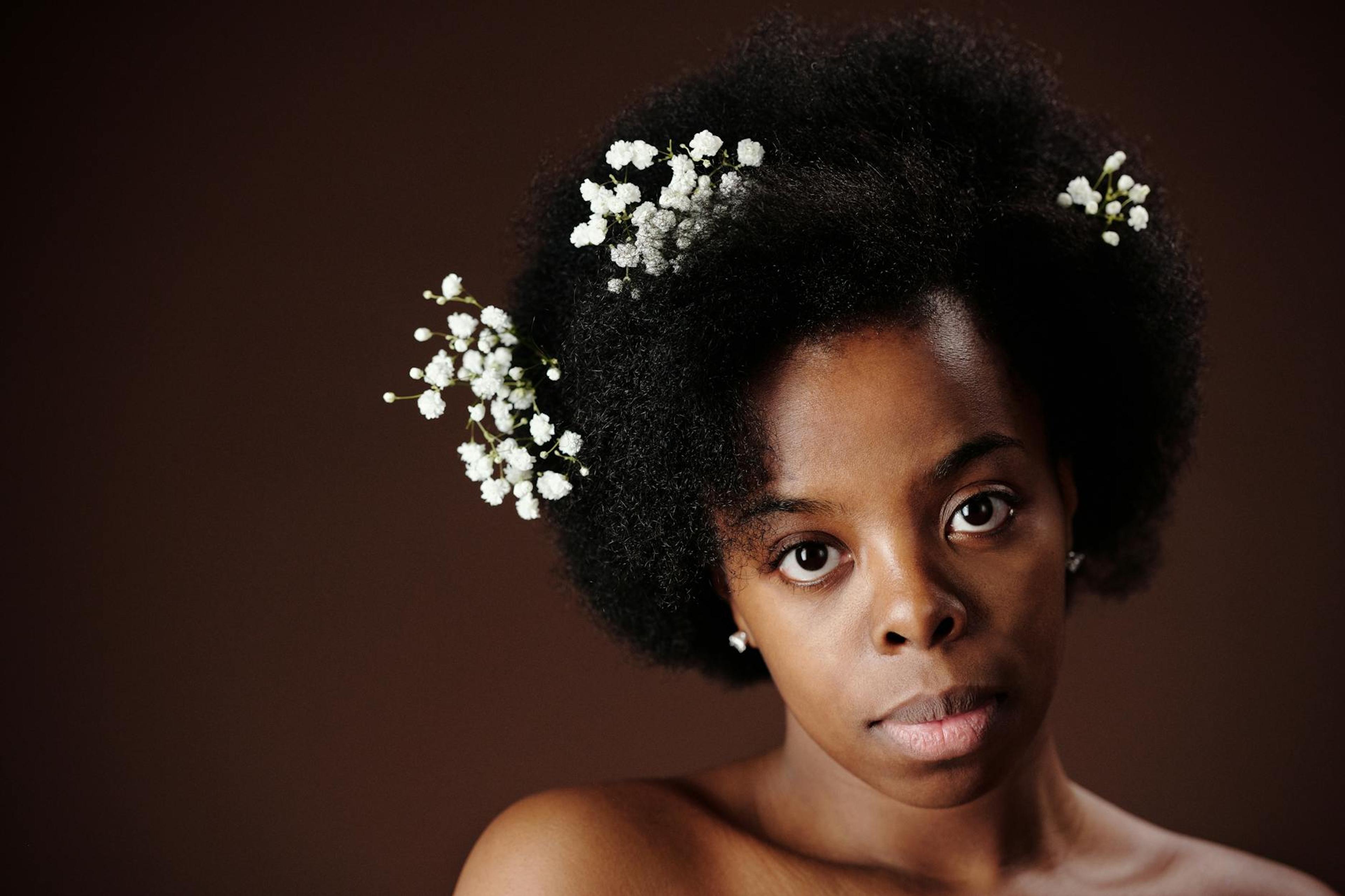 A diverse group of individuals with natural textured hair engaged in a skincare routine, showcasing the importance of melanin in enhancing beauty and skin health.