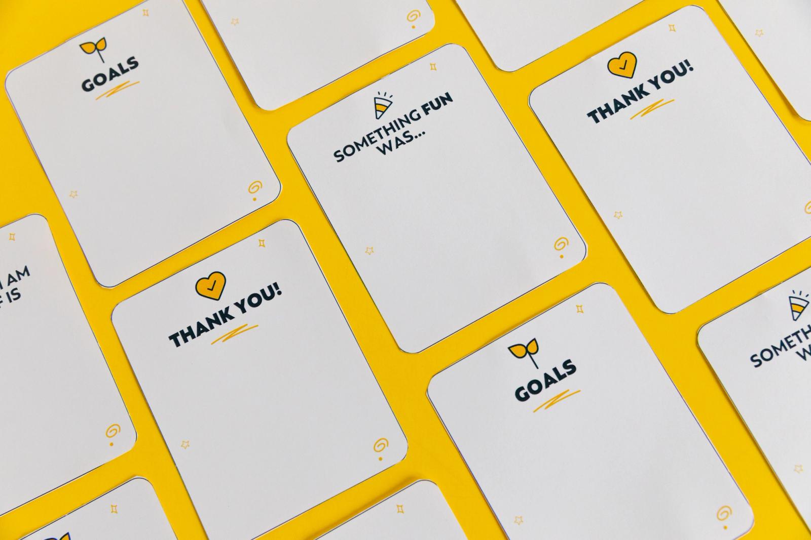 Notecards lay diagonally on a yellow background.