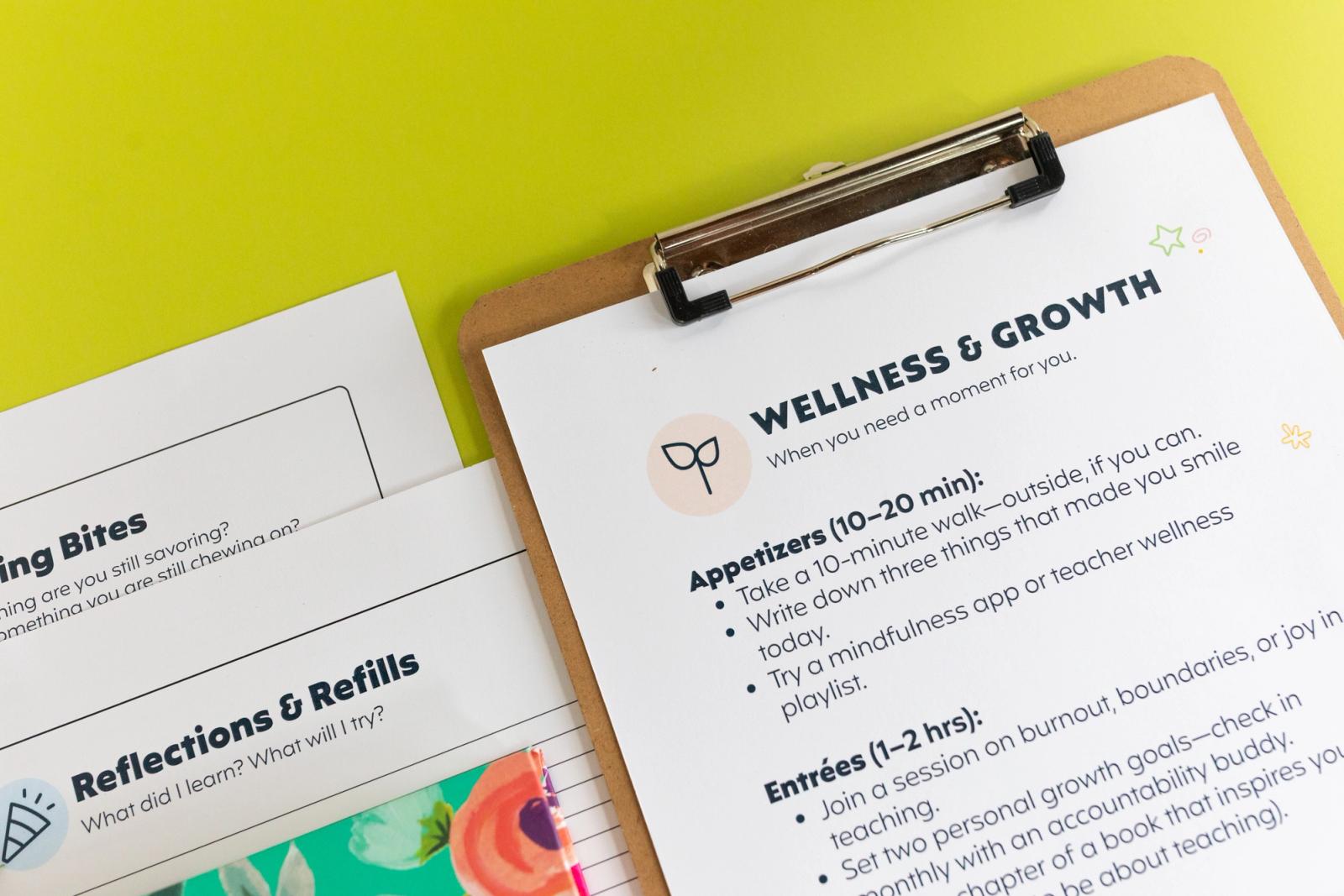 Closeup of a clipboard with a piece of paper that says "wellness and growth" on it sits on a light green background.