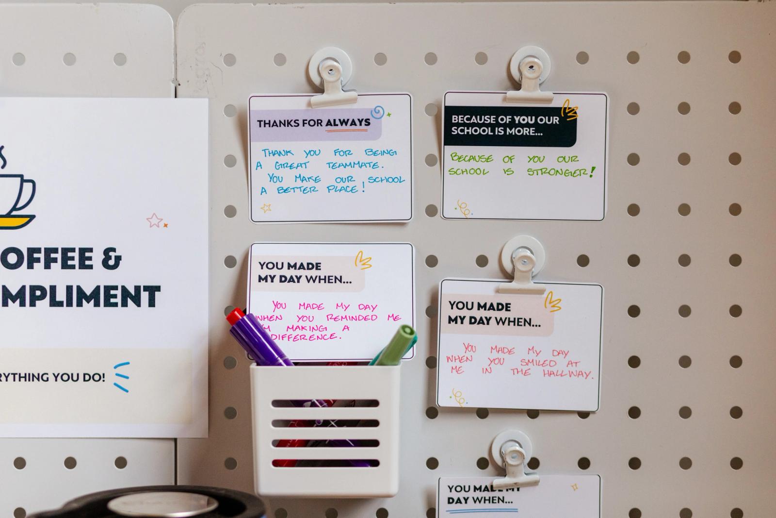 Several hand-written notes are taped to a peg board. 