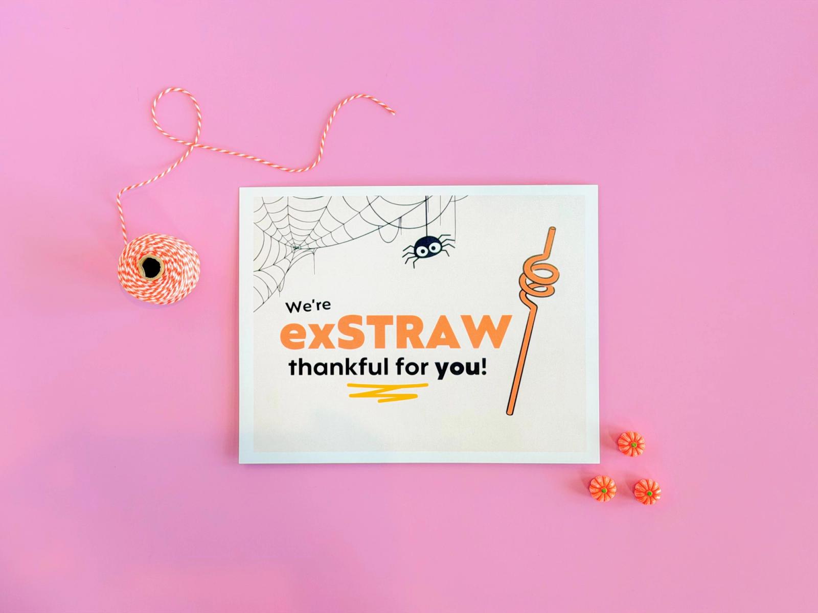 Staff trick or treat sign reading “We’re exSTRAW thankful for you!” with a curly straw, spiderweb, and orange twine