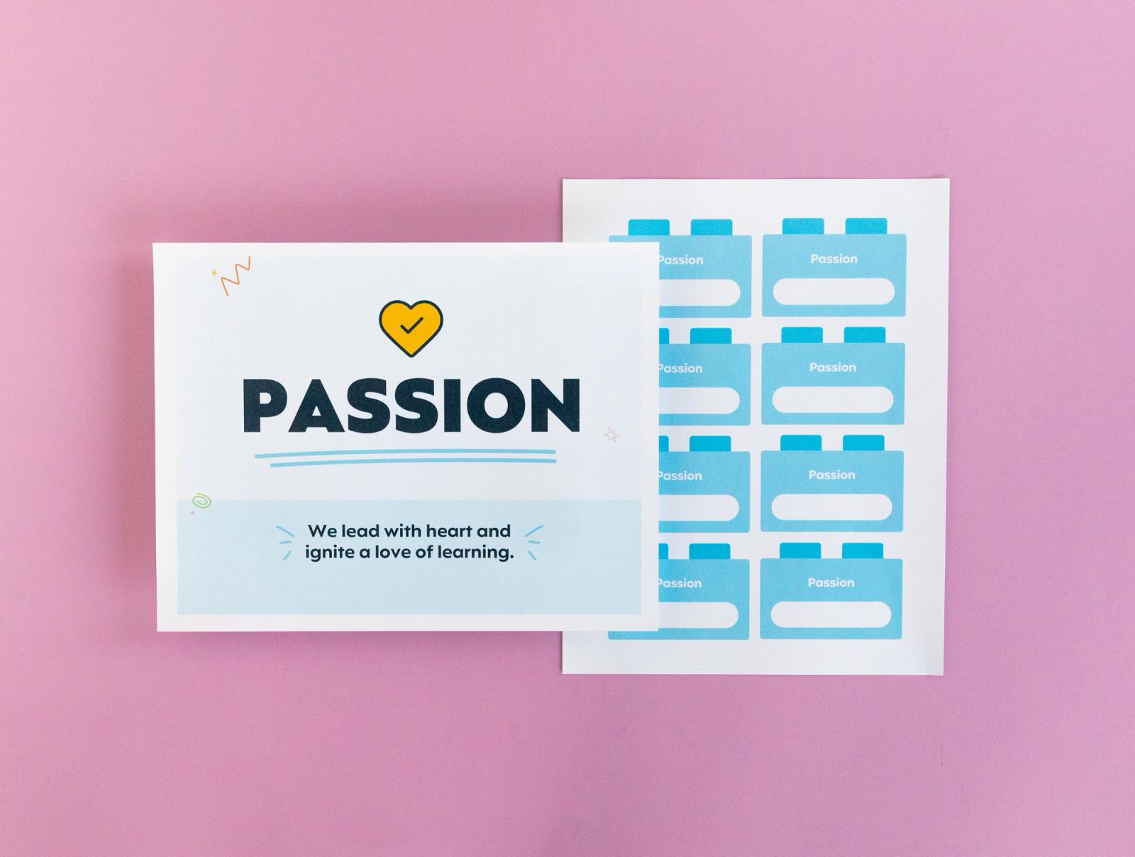 Sheet of paper that says "passion" and another with small squares on it lay on a pink background.