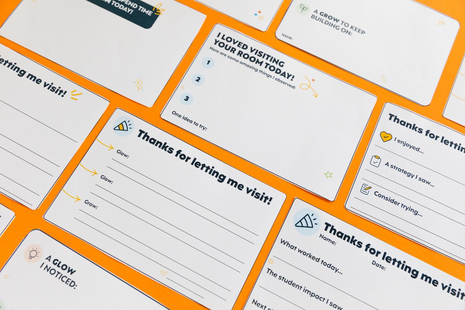 Notecards lay diagonally on an orange background.