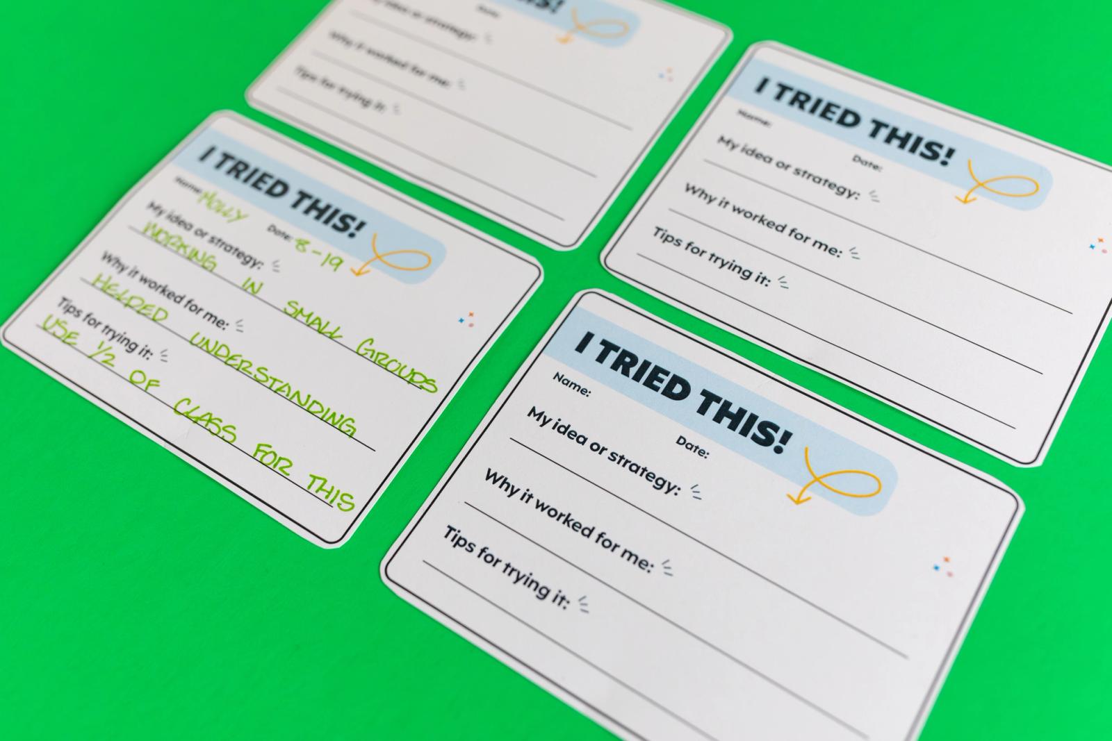 Notecards lay diagonally on a green background.