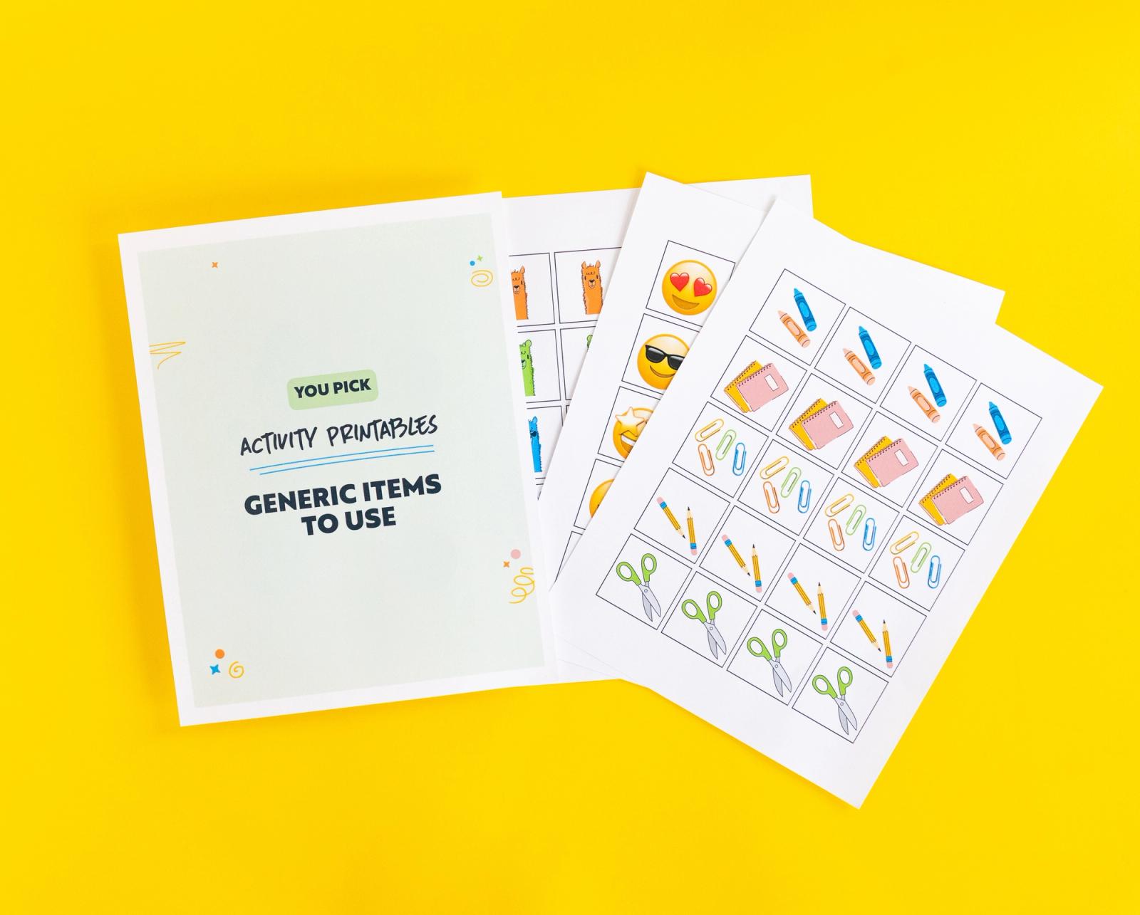 Sheets of paper fanned out with small pictures of school items on them lay on a yellow background.