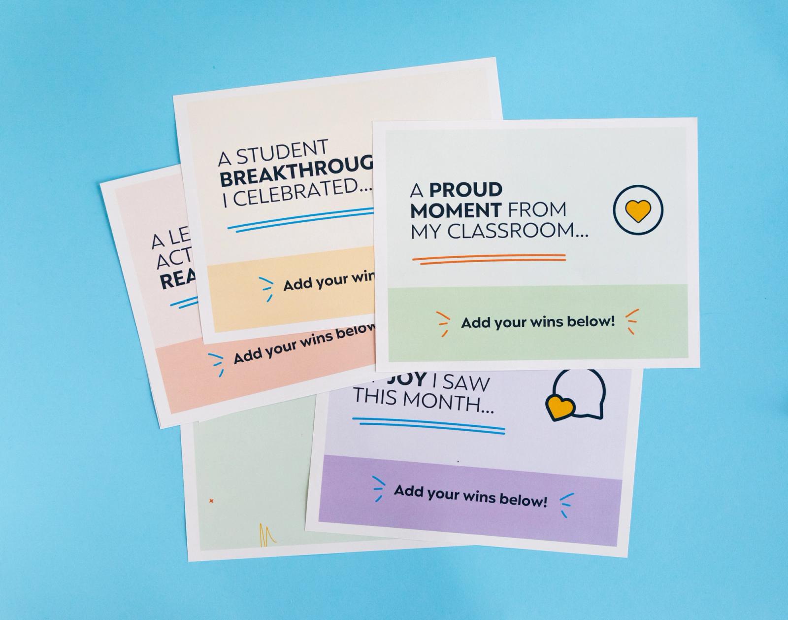 Five posters lay on a light blue background.