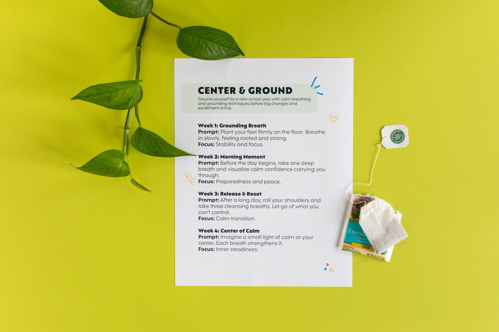 Sheet of paper surrounded by plant vines and a tea bag sits on a bright green background.