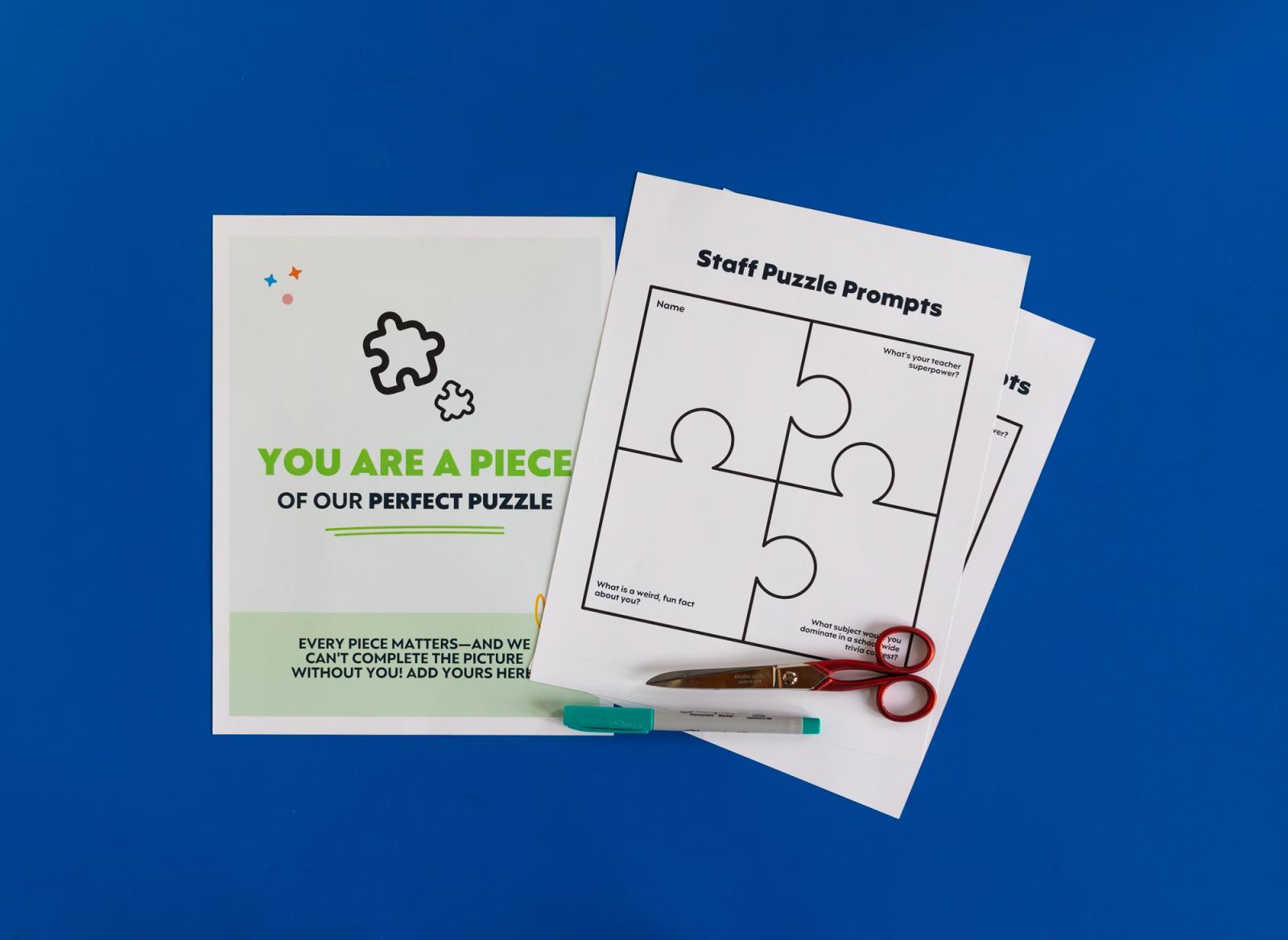Sheets of paper, scissors, and a pen lay on a blue background.