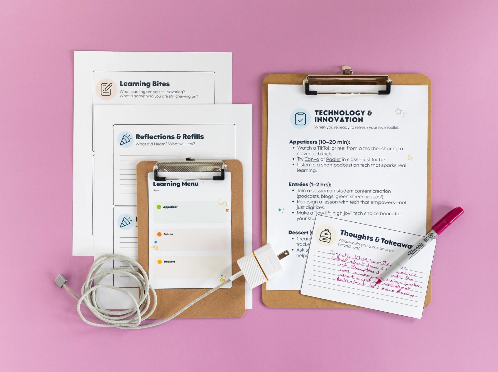 A large clipboard with a piece of paper on it lays on a light purple background. Next to it are more papers and a smaller clipboard with a "learning menu" on it. A cord charger lays on top.