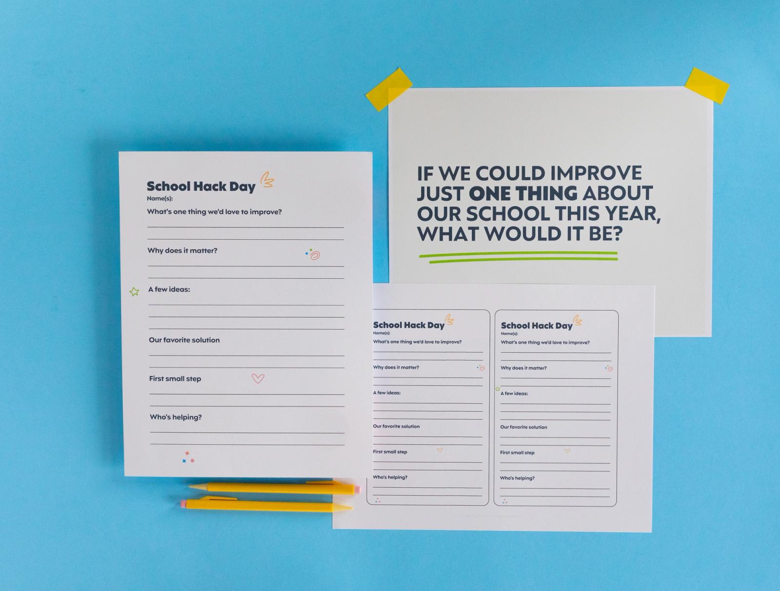 Three sheets of paper and pencils lay on a light blue background.