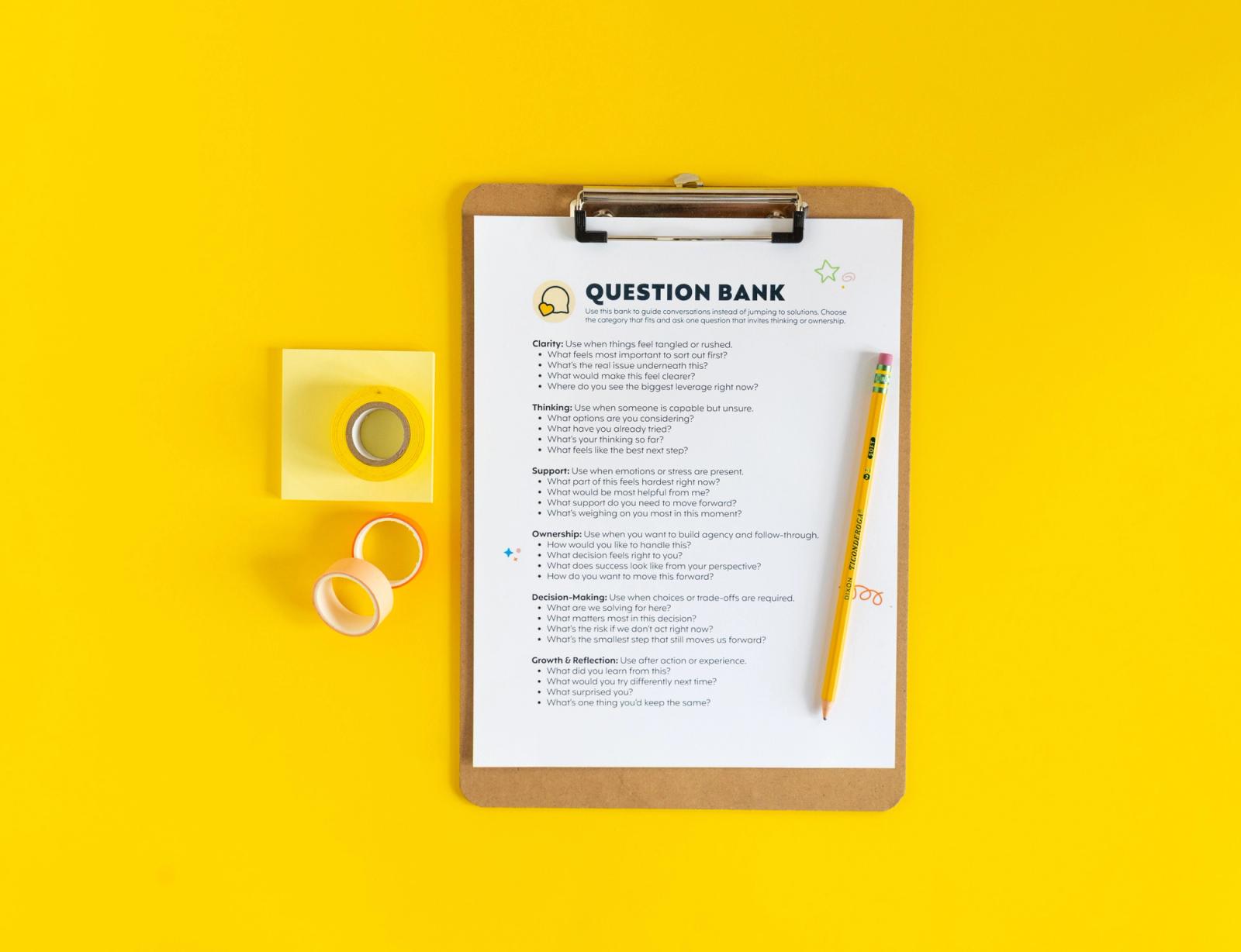 A clipboard with a sheet of paper with a list of questions lays on a yellow background. A pencil is on top of the paper, and rolls of tape and yellow sticky-notes lay next to it.