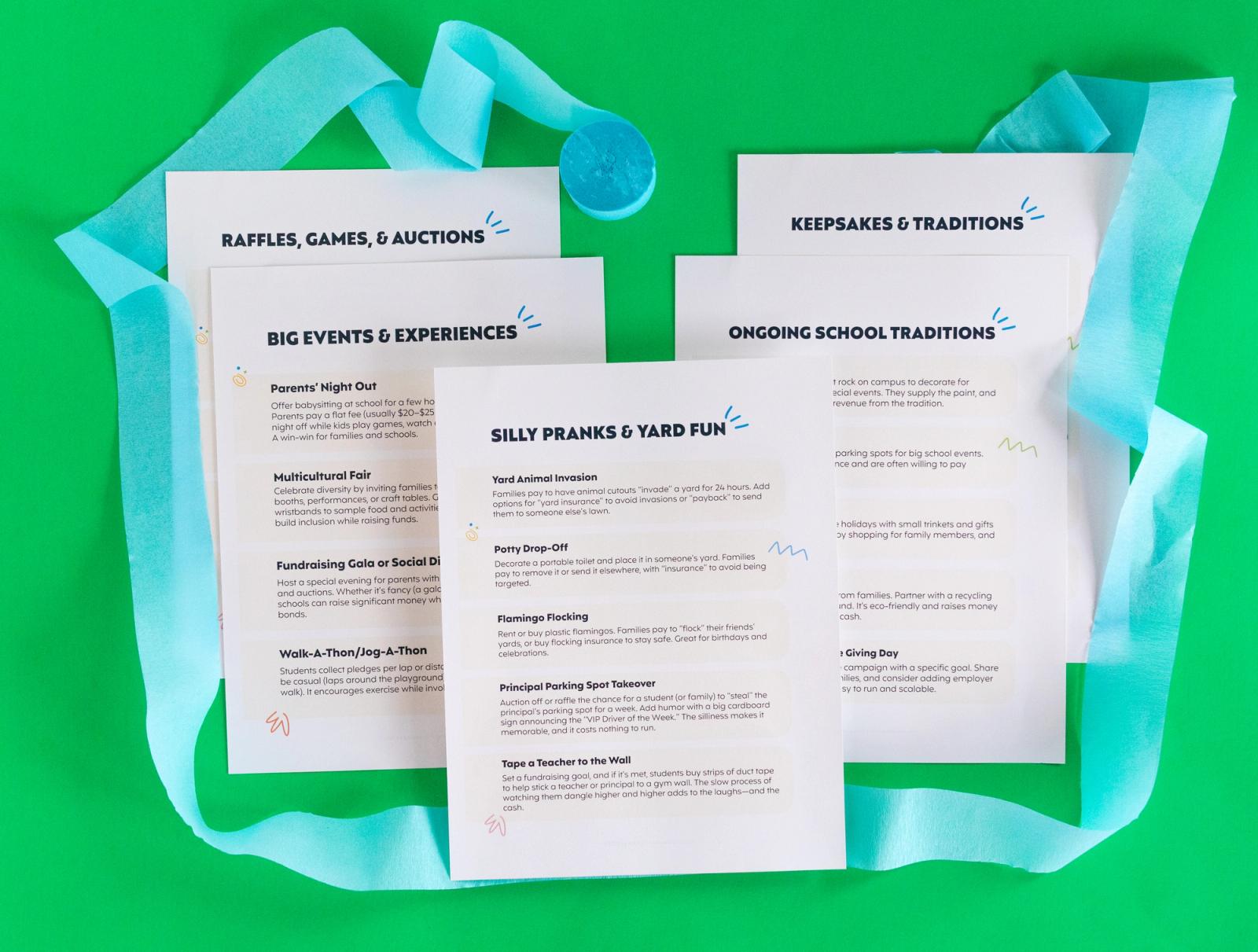 Five sheets of paper lay on a green background with blue streamers around them.