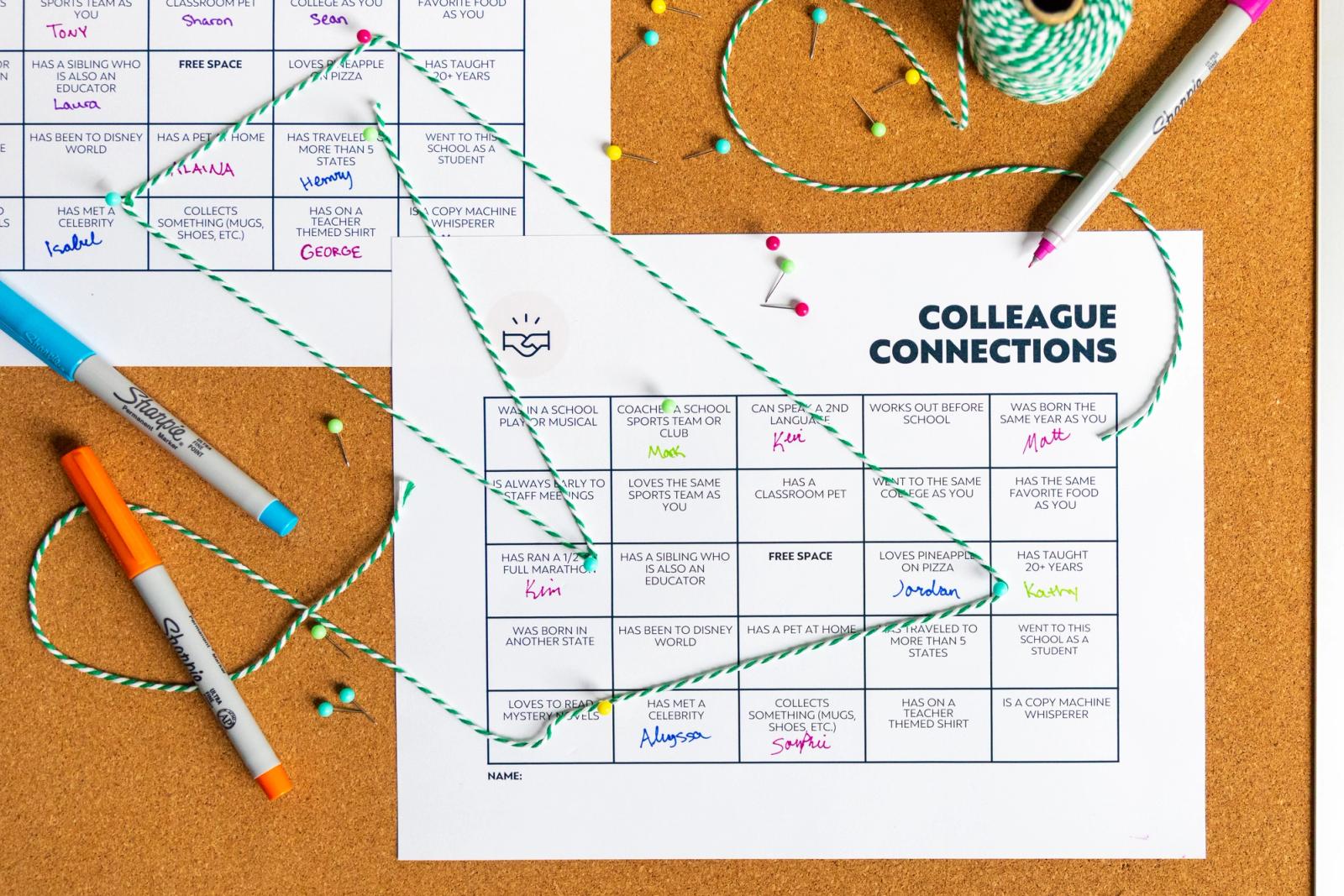 Two pieces of paper pinned to a bulletin board with a grid printed on them. Green string connects squares from each paper. Colorful pens lay around the papers.