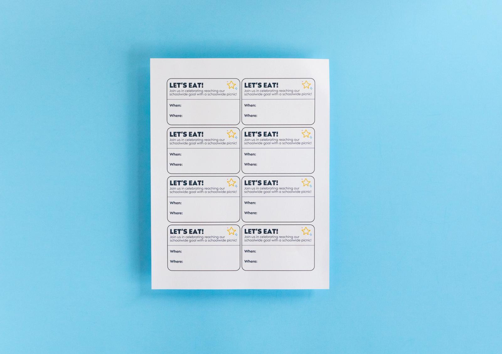Sheet with coupons that say "let's eat" lays on a light blue background.