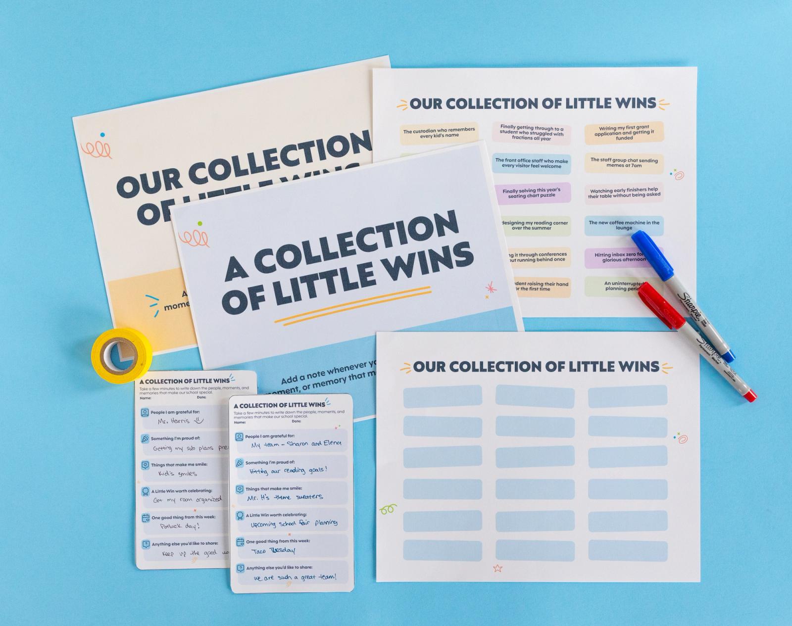 Several sheets of paper, small notecards, pens, and a roll of tape lay on a light blue background.