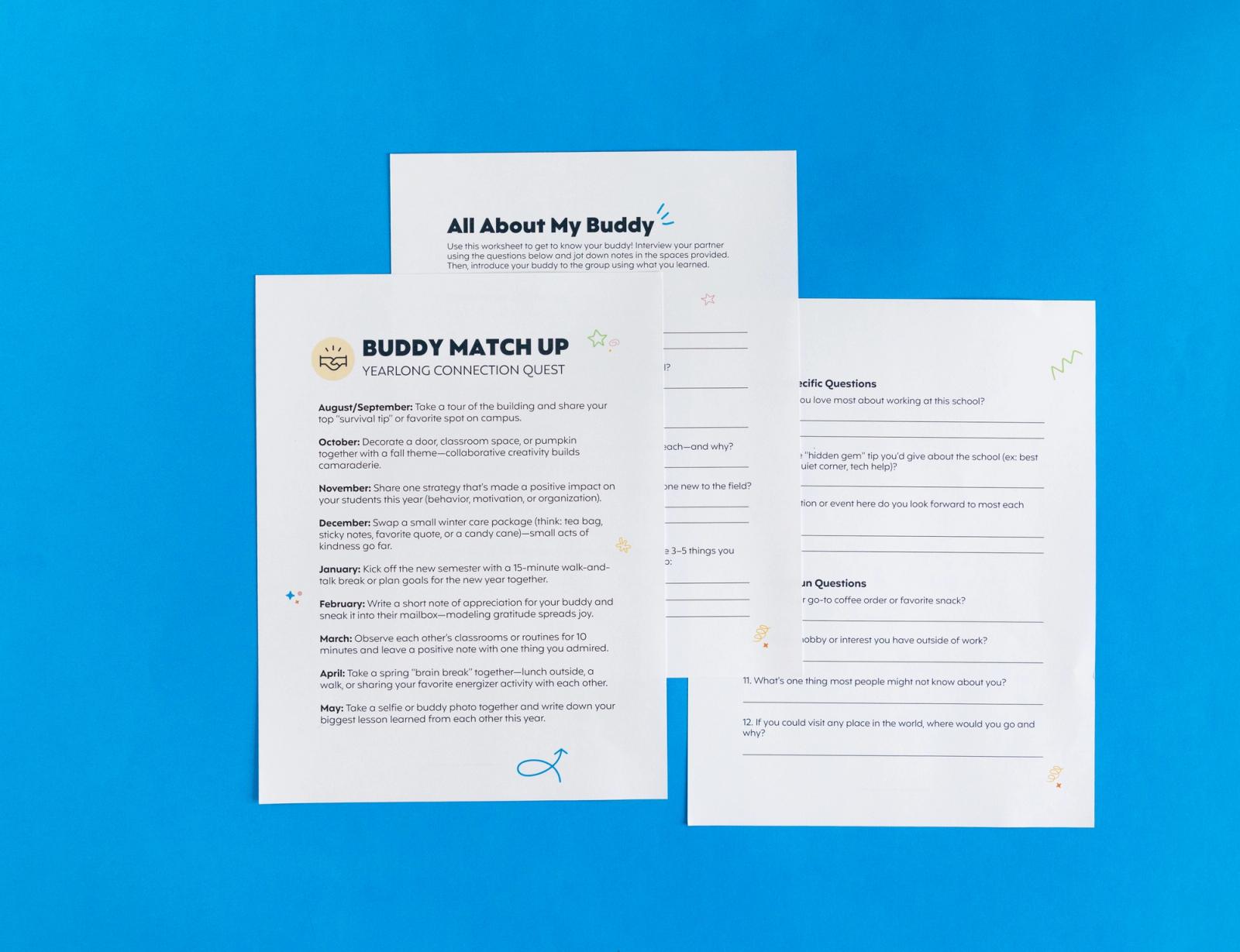 Three sheets of paper that say "buddy match-up" lays on a blue background.