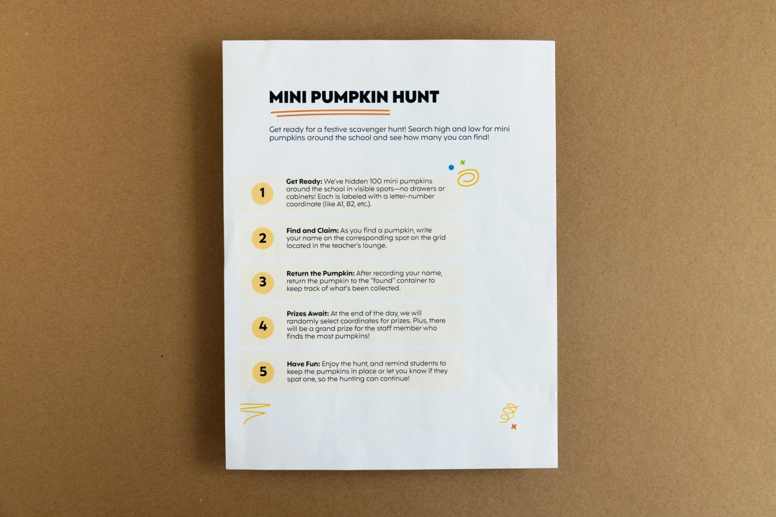 A piece of paper that says "mini pumpkin hunt" lays on a brown background.