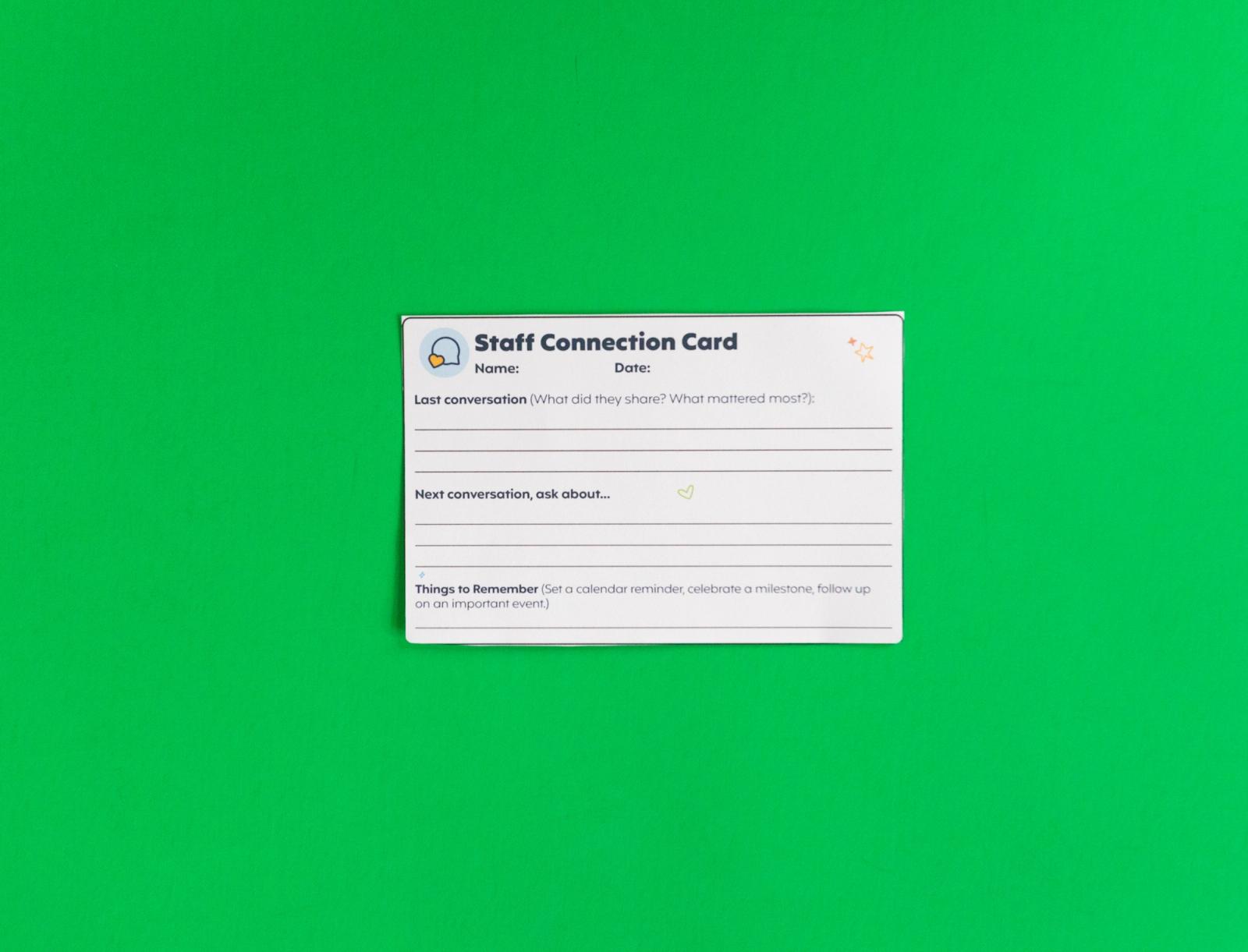 A notecard that says "staff connection card" lays on a green background.
