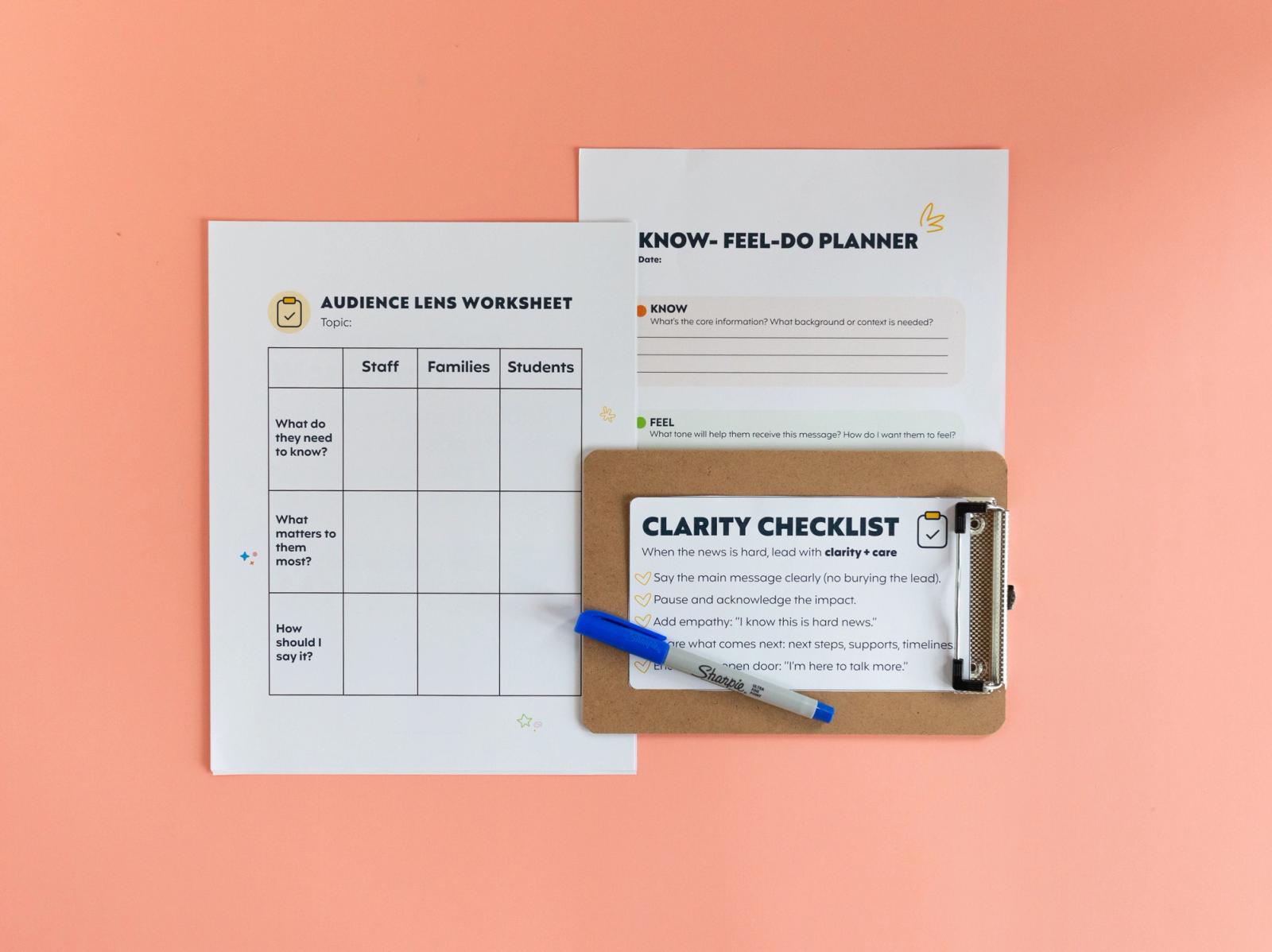 Two sheets of paper, a clipboard with a paper on it, and a blue pen lay on a salmon background.