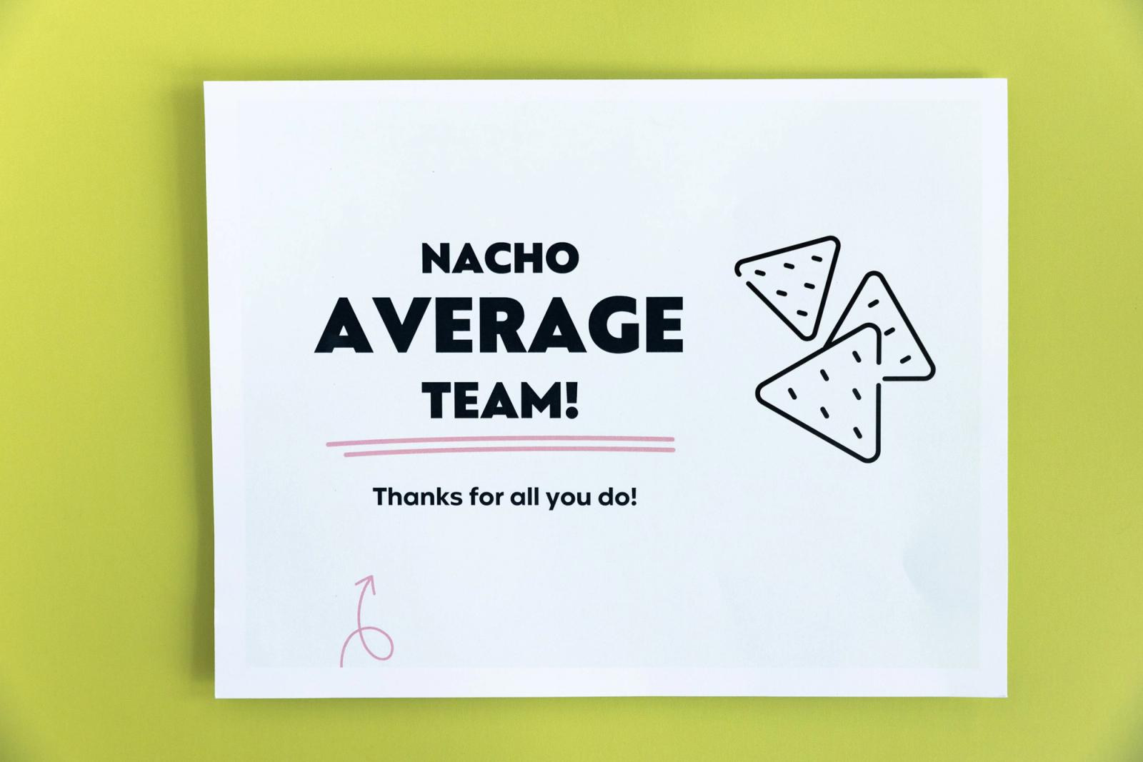 A paper that says "nacho average team" lays on a light green background.