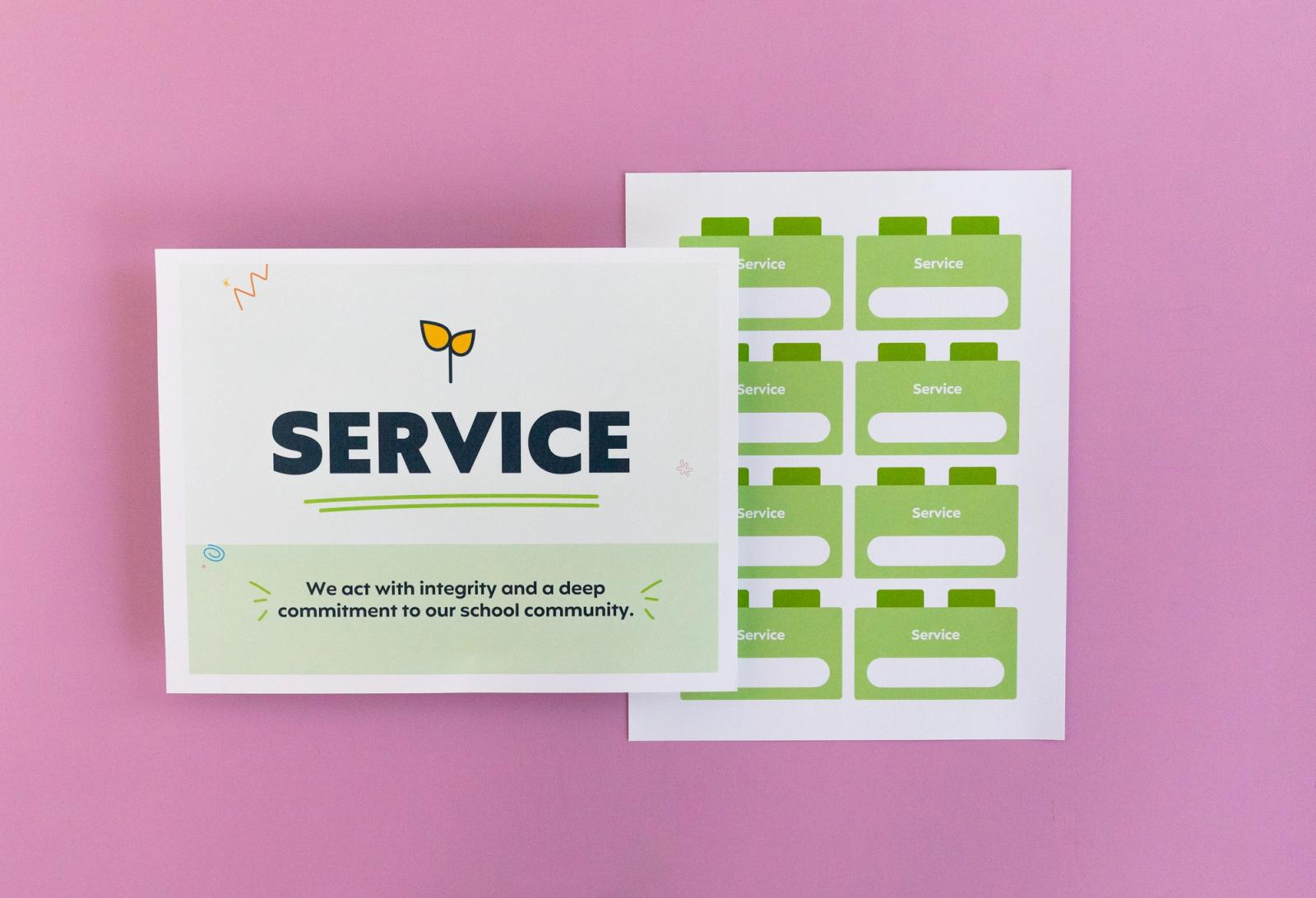 Sheet of paper that says "service" and another with small squares on it lay on a pink background.