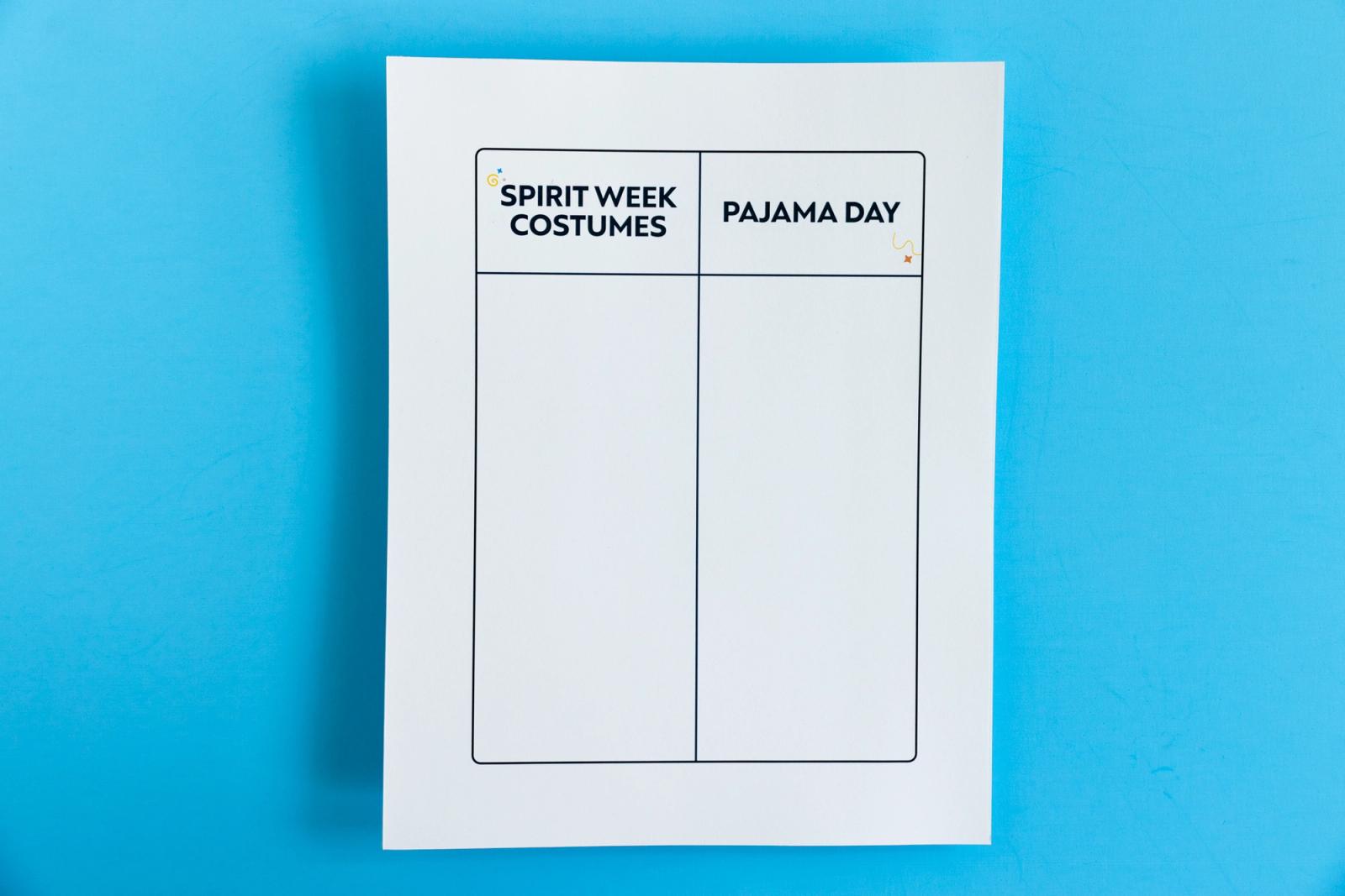 Sheet of paper that says "spirit week costumes" and "pajama day" on it lays on a light blue background.