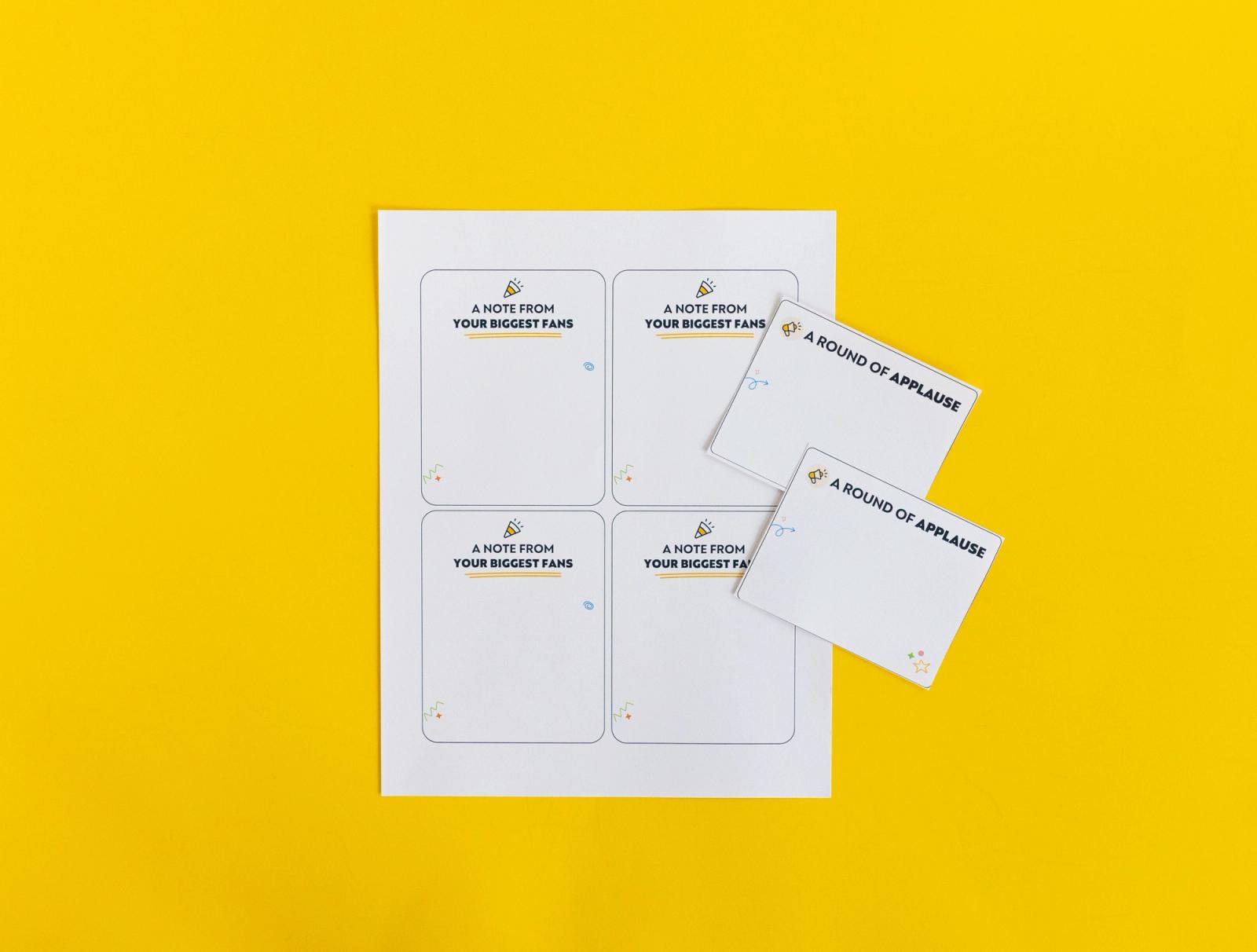 A sheet of paper with notecards on it lays on a yellow background.