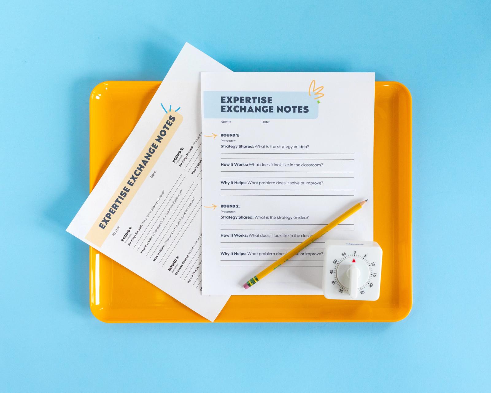 Two sheets of paper, pencil, and timer lay on an orange tray on a light blue background.