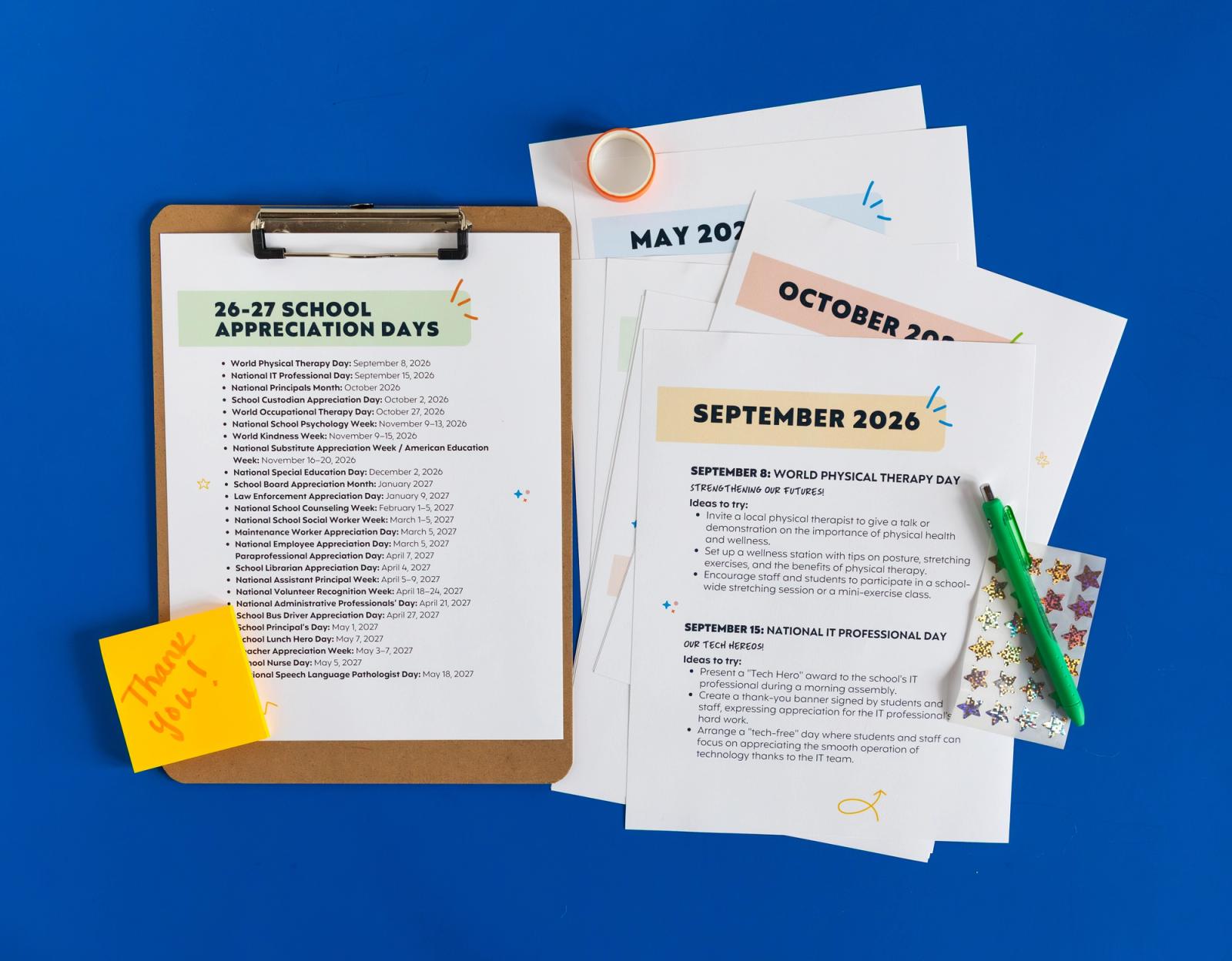 Several sheets of paper lay on a bright blue background. To the right of them is a clipboard with a sheet of paper on it. Sticky notes, pens, stickers and tape are scattered around them.