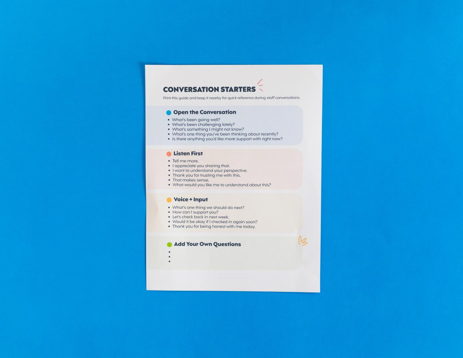 Sheet of paper that says "conversation starters" lays on a blue background.