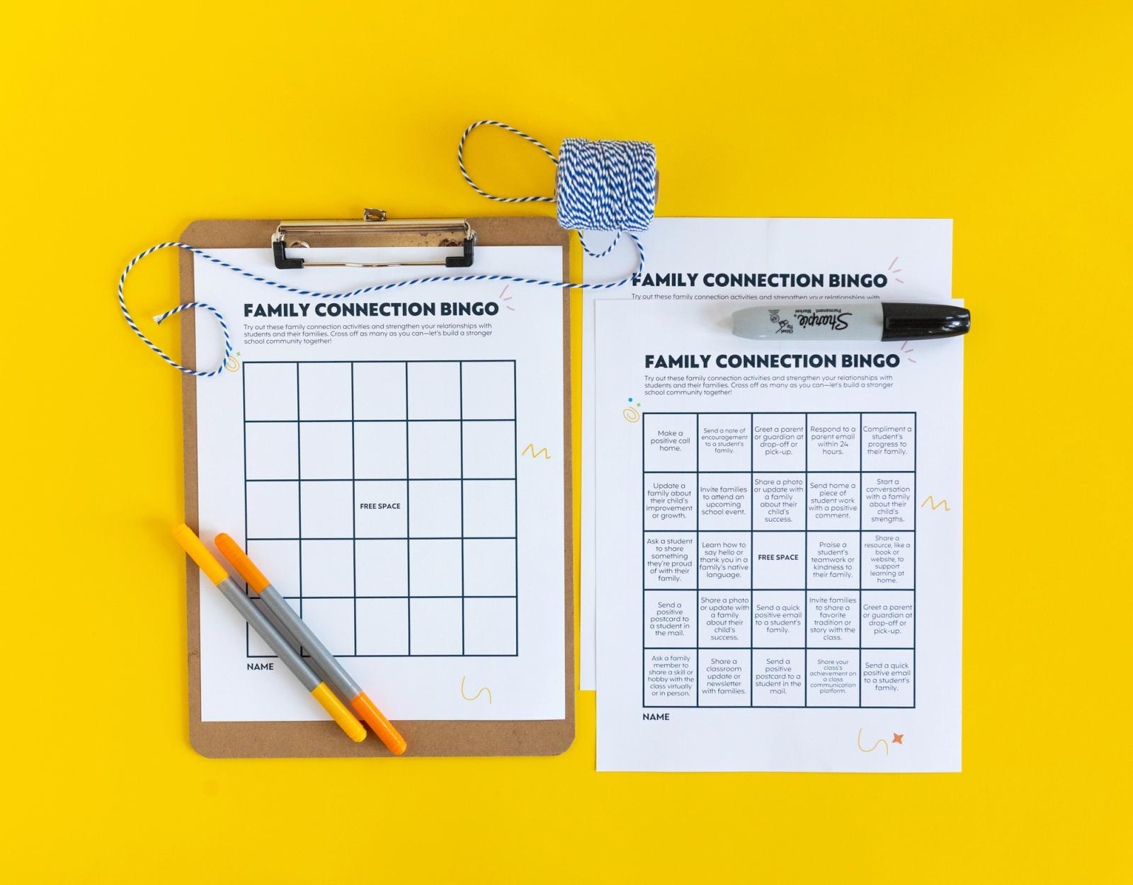 A blank bingo card on a clipboard with a yellow and orange pen on top of it lays on a yellow background. Beside it is a full bingo card and a black marker. 