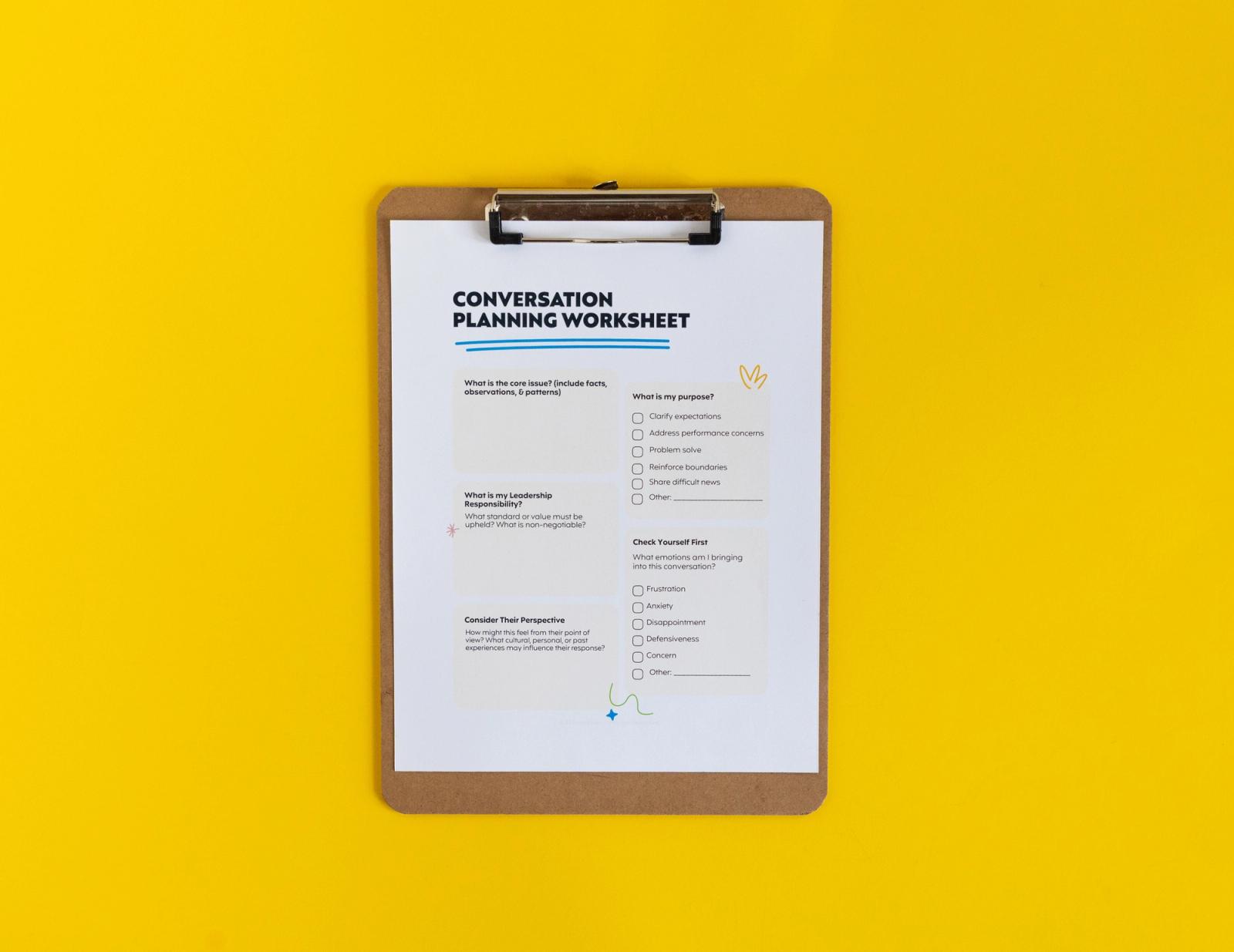 Clipboard with a sheet of paper that says "conversation planning worksheet' lays on a yellow background.