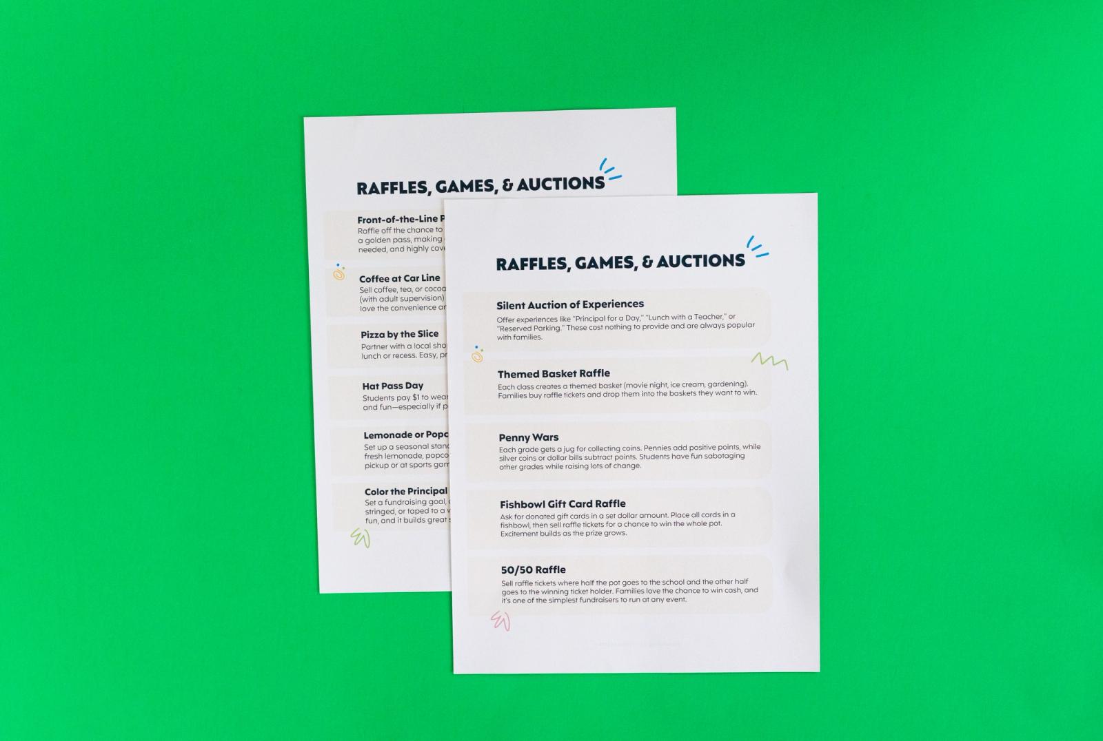 Two sheets of paper that say "raffles, games, and auctions" on it lay on a green background.