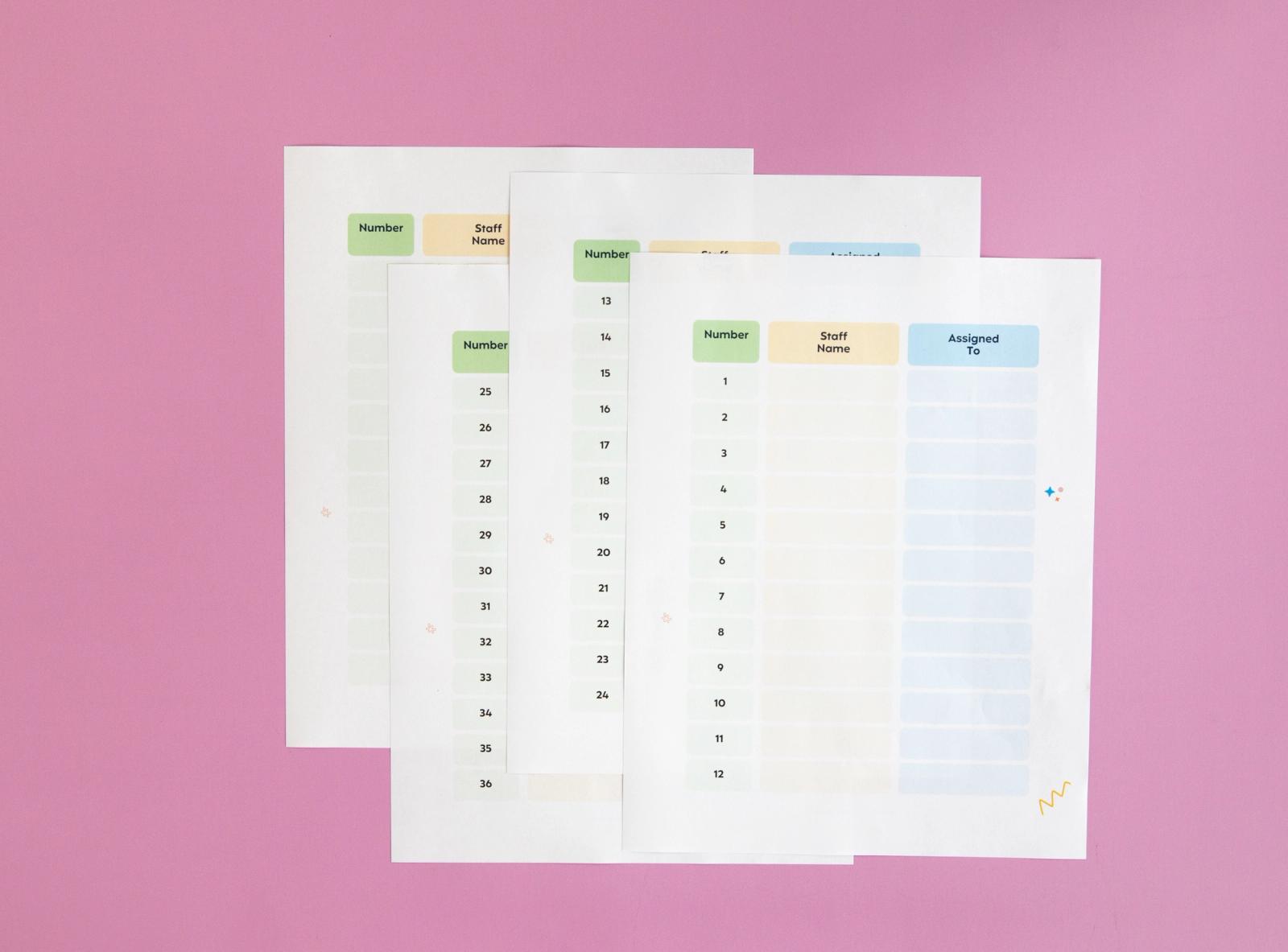 Sheets of paper lay on a pink background.