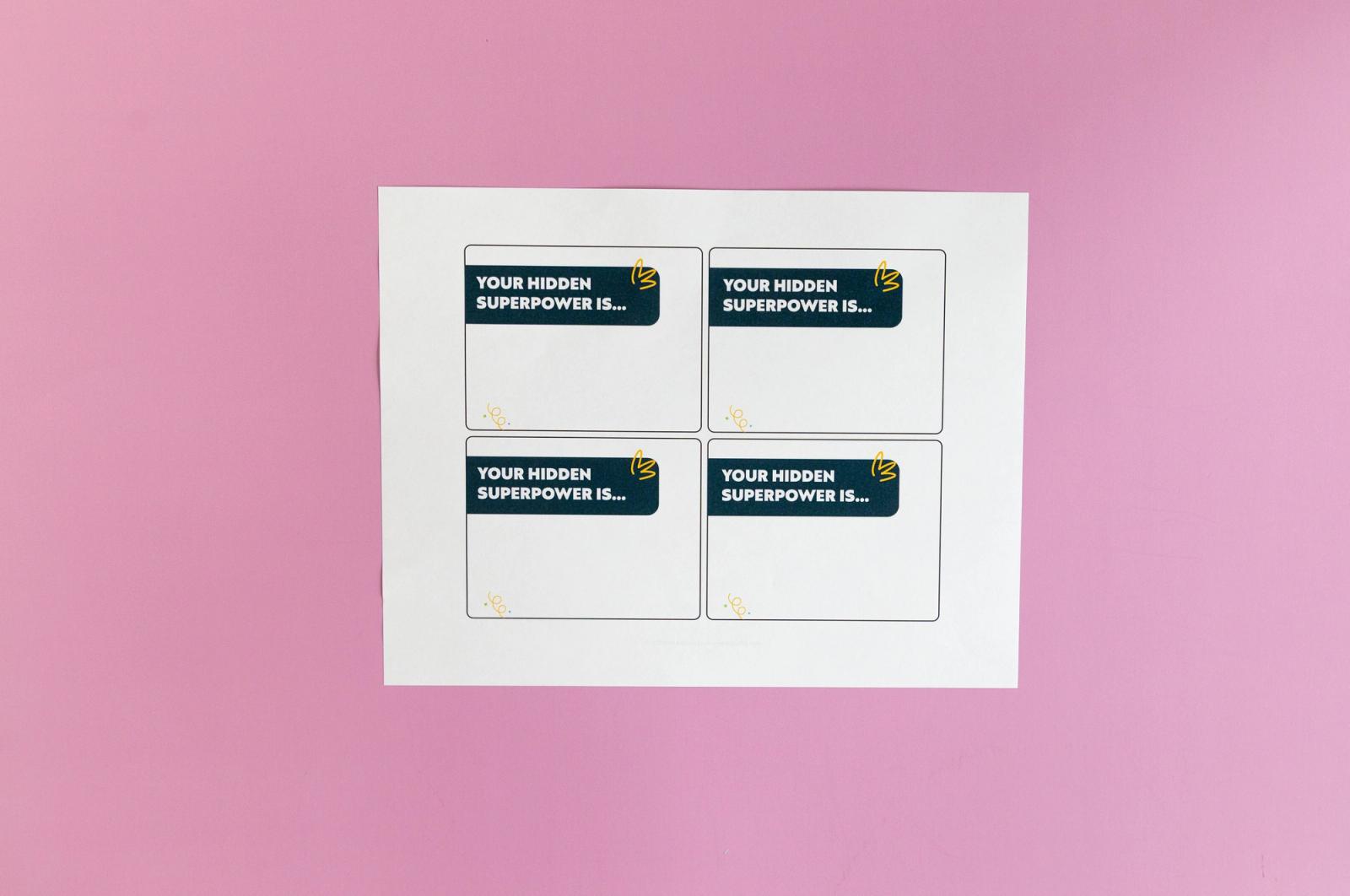 Sheet of paper with notecards that say "your hidden superpower is" lays on a pink background.