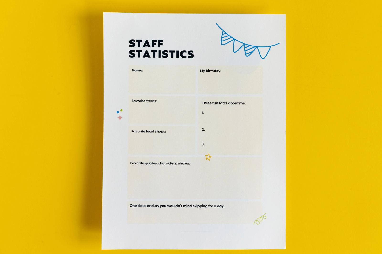 A piece of paper that says "staff statistics" lay on a yellow background.