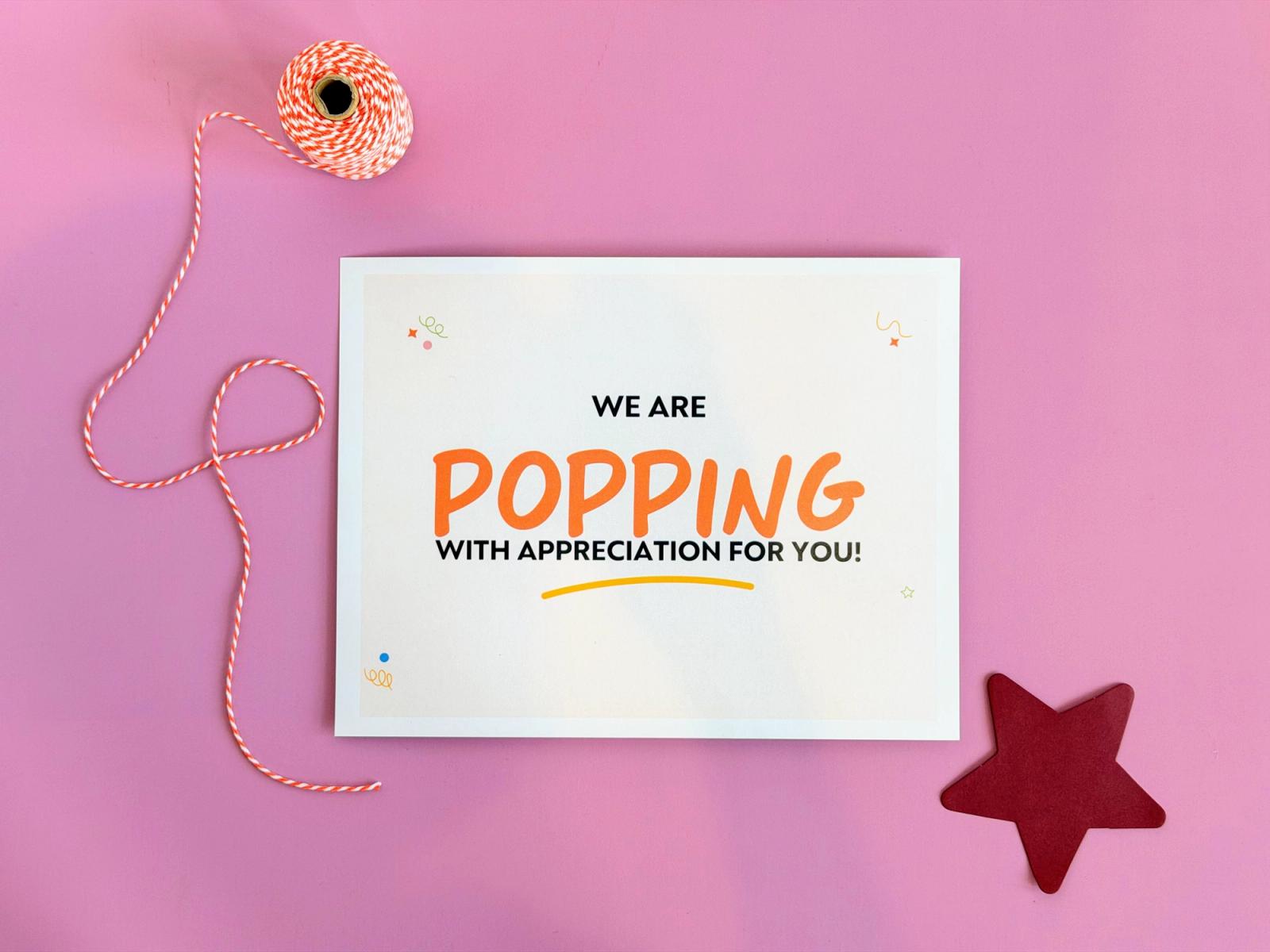 Staff trick or treat sign reading “We are popping with appreciation for you!” with orange twine and a red star