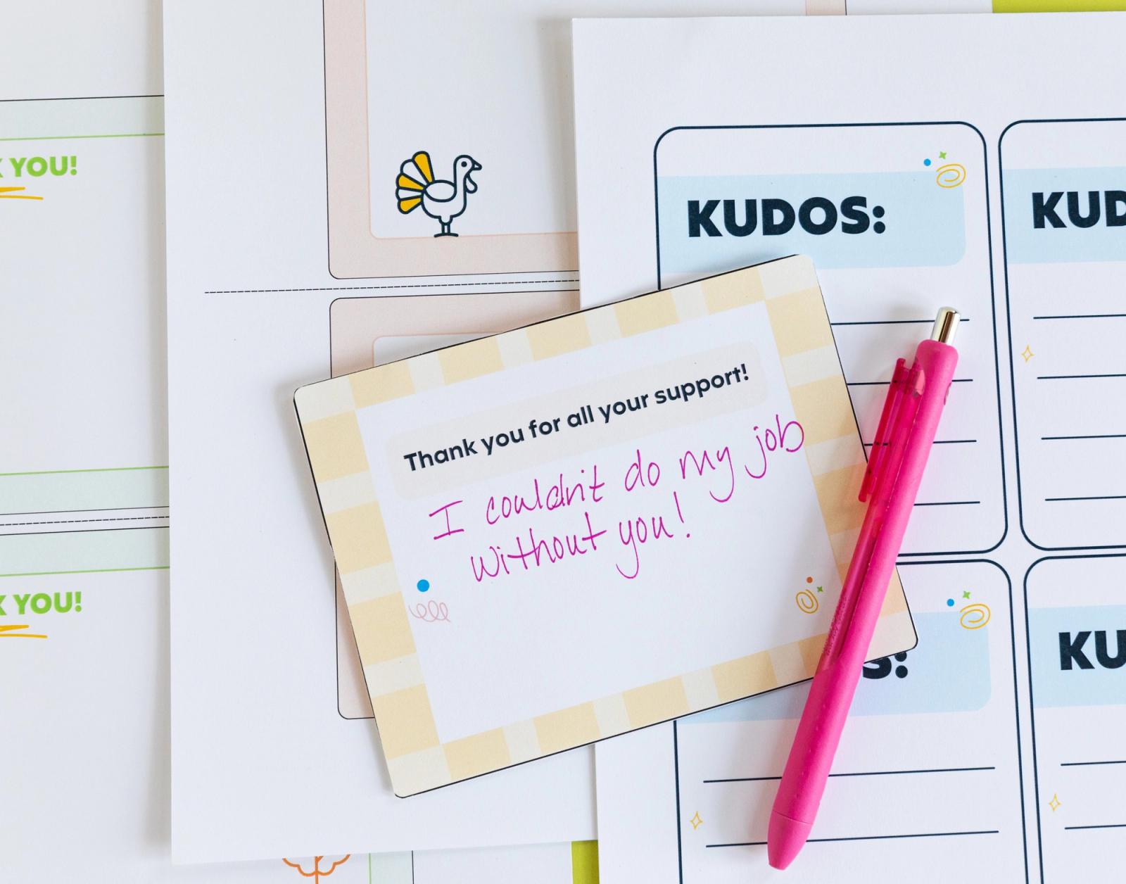Closeup of a handwritten note and a pink pen laying on sheets of paper.