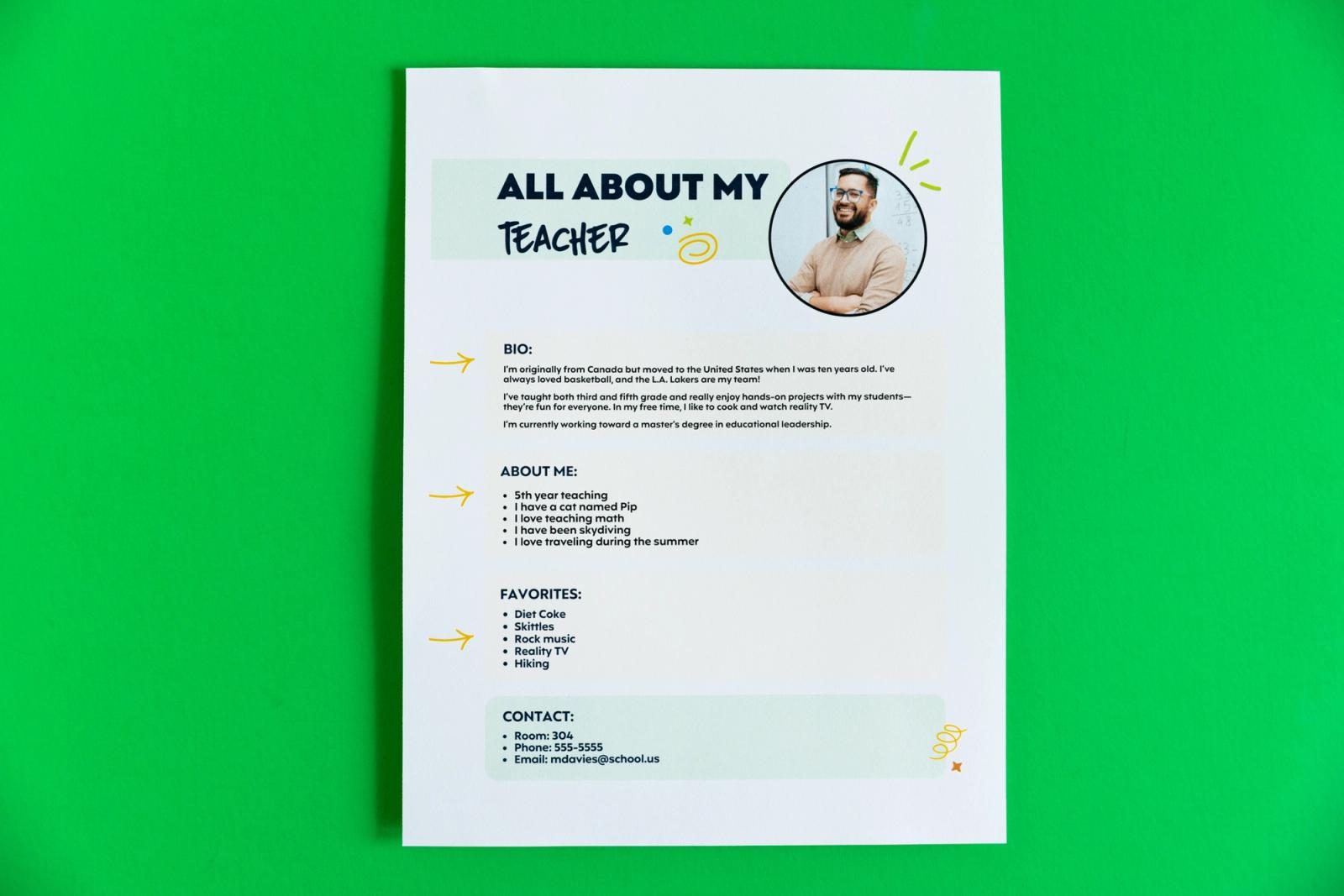 A piece of paper that says "all about my teacher" lays on a green background.