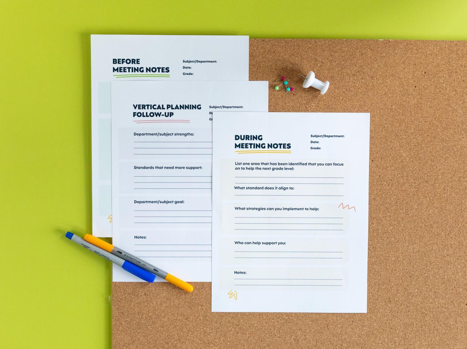 Three pieces of paper lay on a cork board with pens and push pins on top of a bright green background.